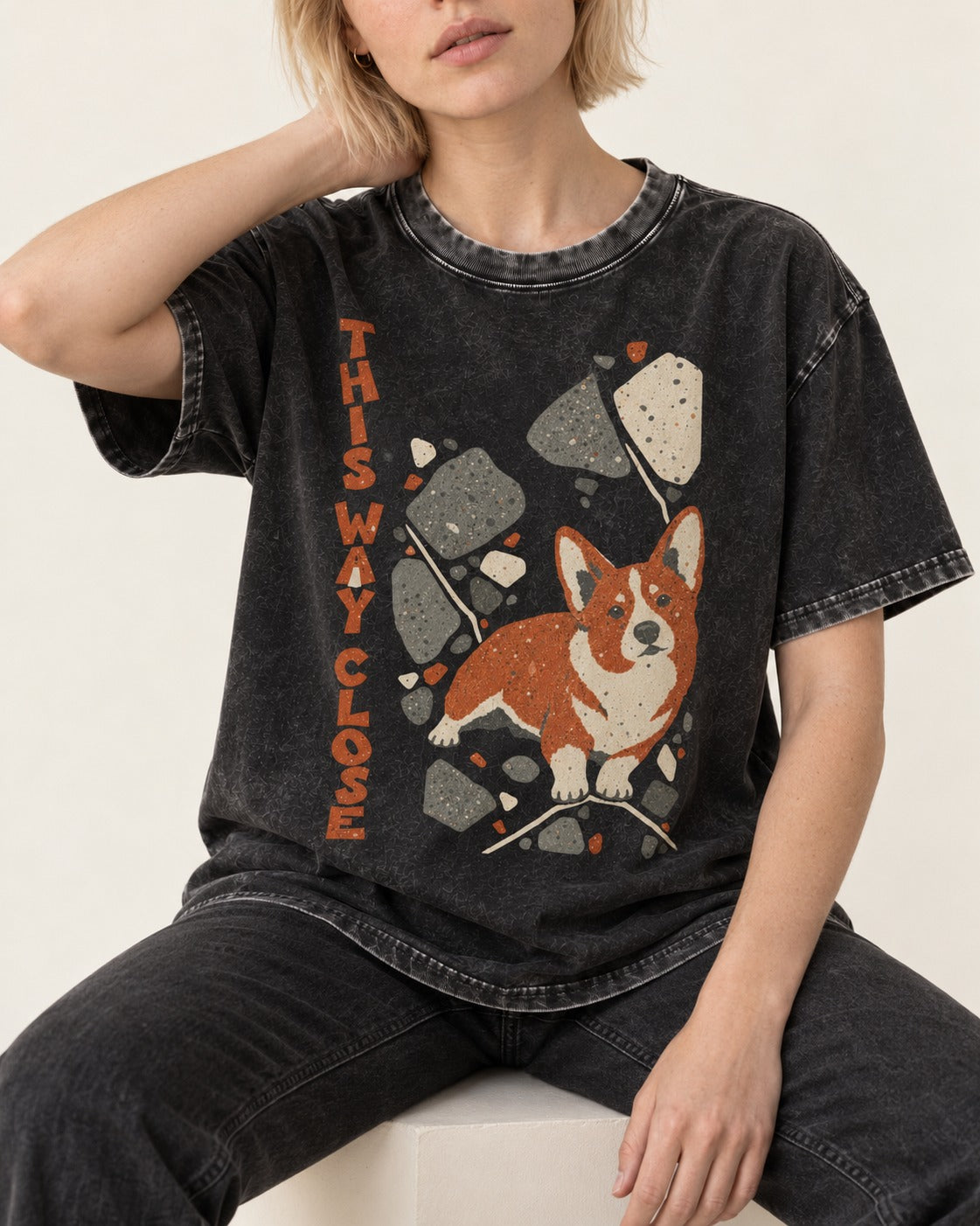Corgi This Way Close Rubble Graphic Washed Tee in Black, worn by a seated model