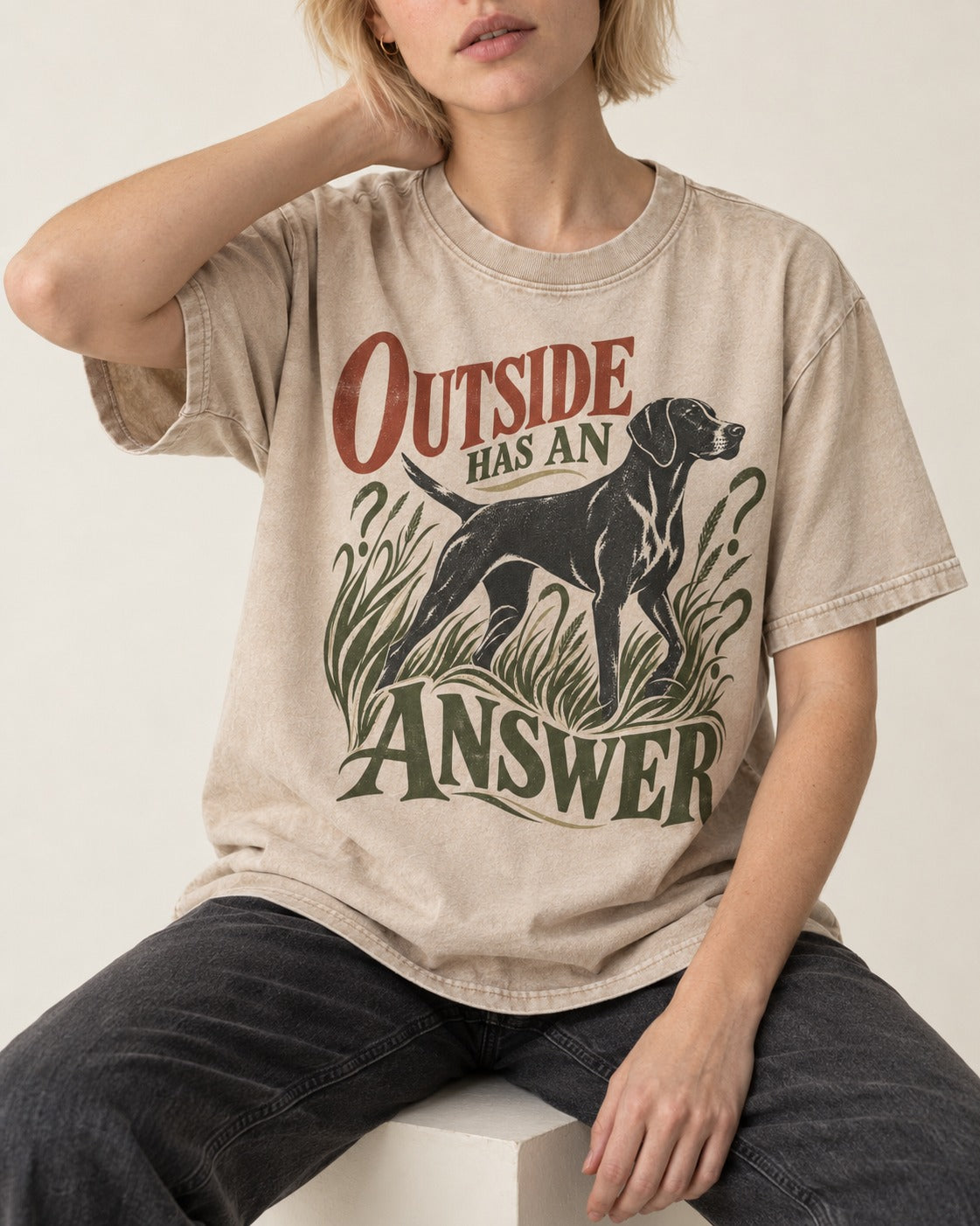 Outside Has an Answer German Shorthaired Pointer Washed Tee in Apricot, worn by a seated model