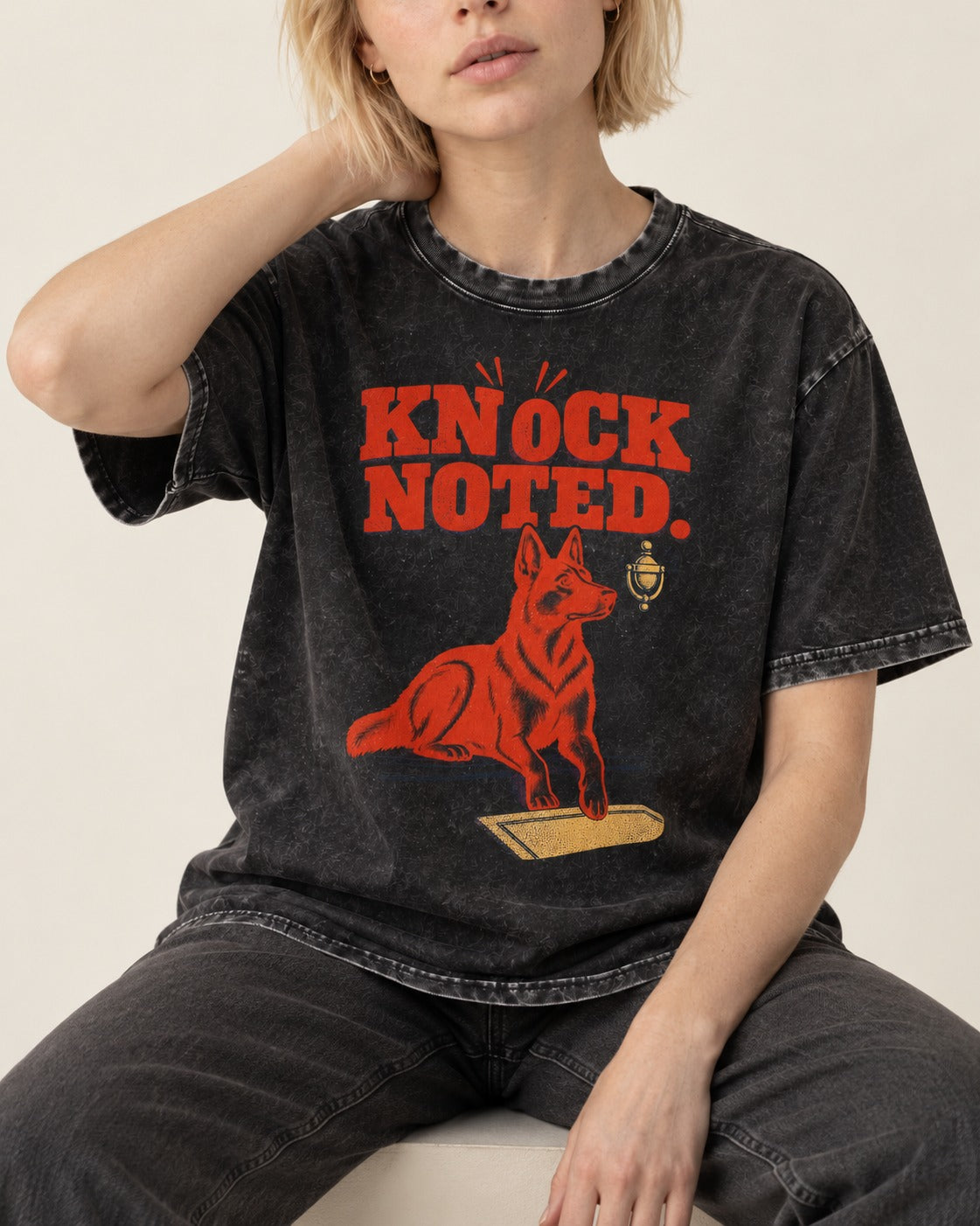 Knock Noted Door Knocker German Shepherd Dog Graphic Washed Tee in Black, worn by a seated model