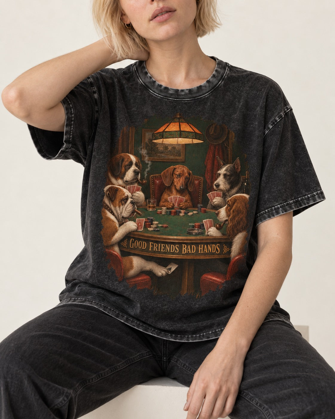 Dachshund Good Friends Bad Hands Poker Scene Washed Tee in Black, worn by a seated model