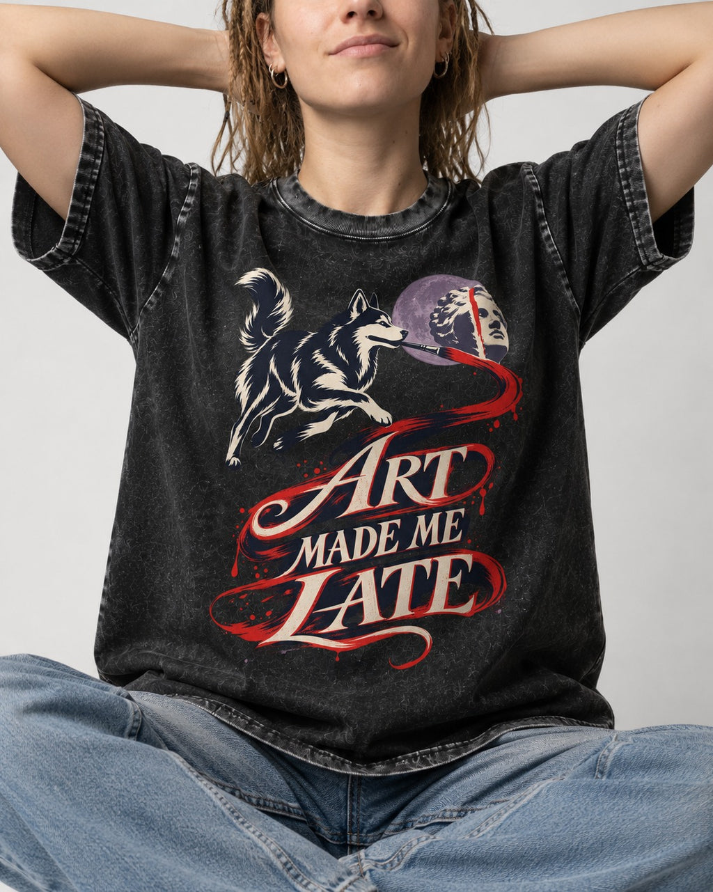 Husky Art Made Me Late Paintbrush Graphic Washed Tee in Black, worn by a seated model