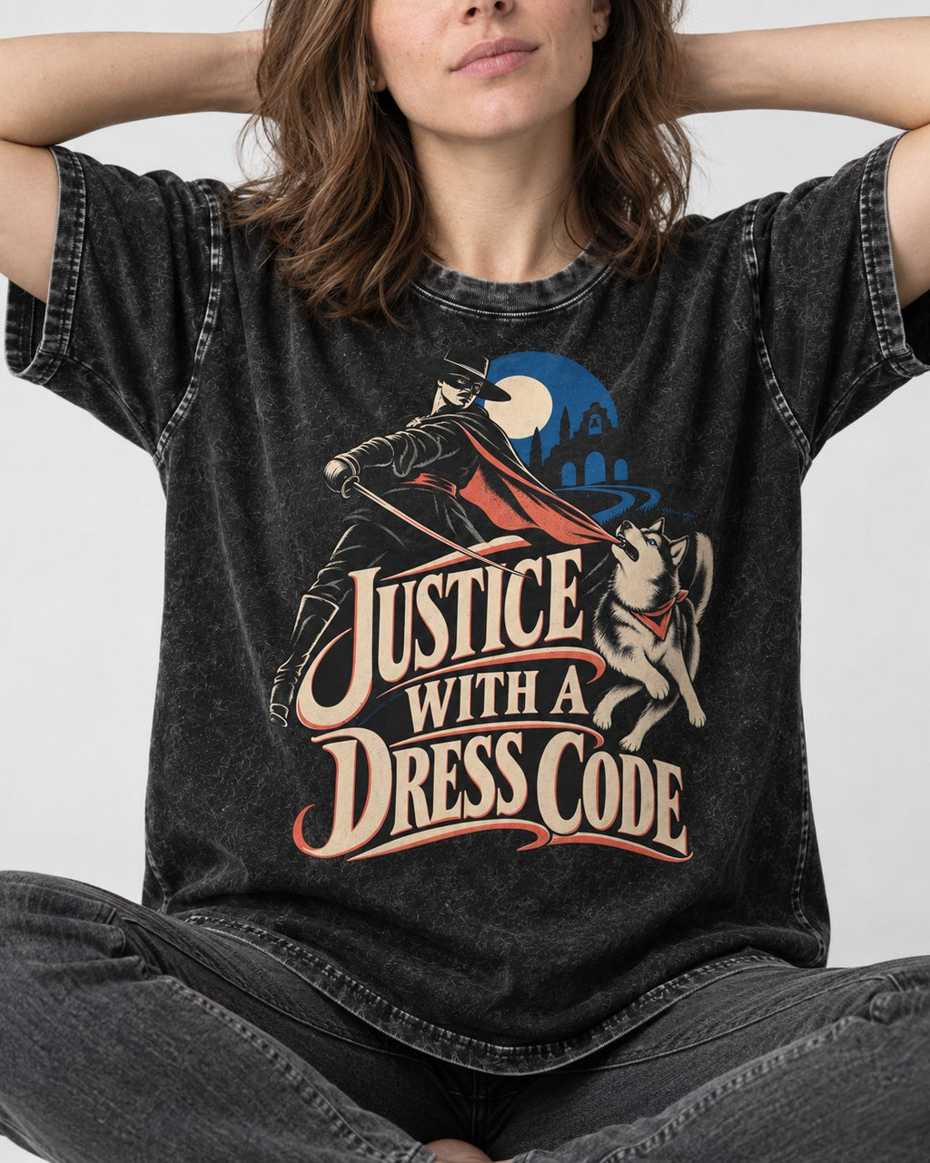 Husky Justice With A Dress Code Masked Swordsman Graphic Washed Tee in Black, worn by a seated model