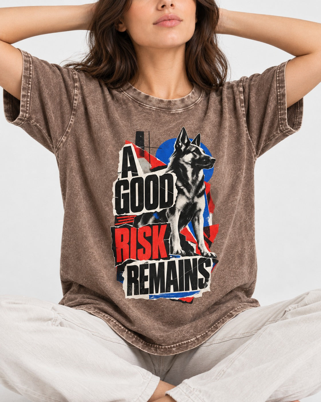 A Good Risk Remains German Shepherd Dog Washed Tee in Coffee, worn by a seated model