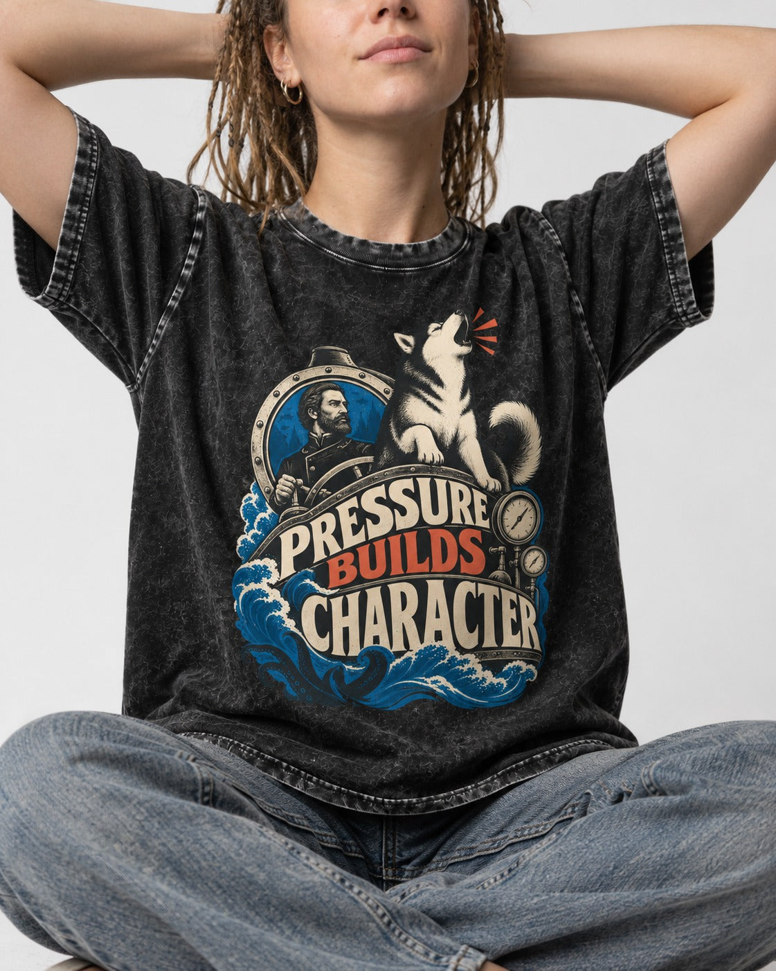 Husky Pressure Builds Character Deep Sea Graphic Washed Tee in Black, worn by a seated model