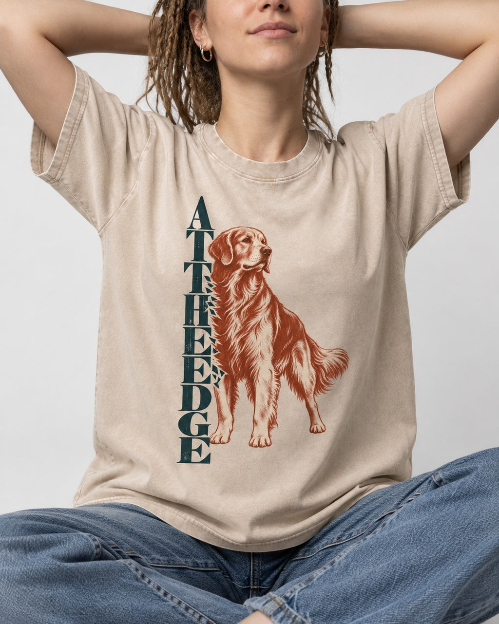 Golden Retriever At the Edge Washed Tee in Apricot, worn by a seated model