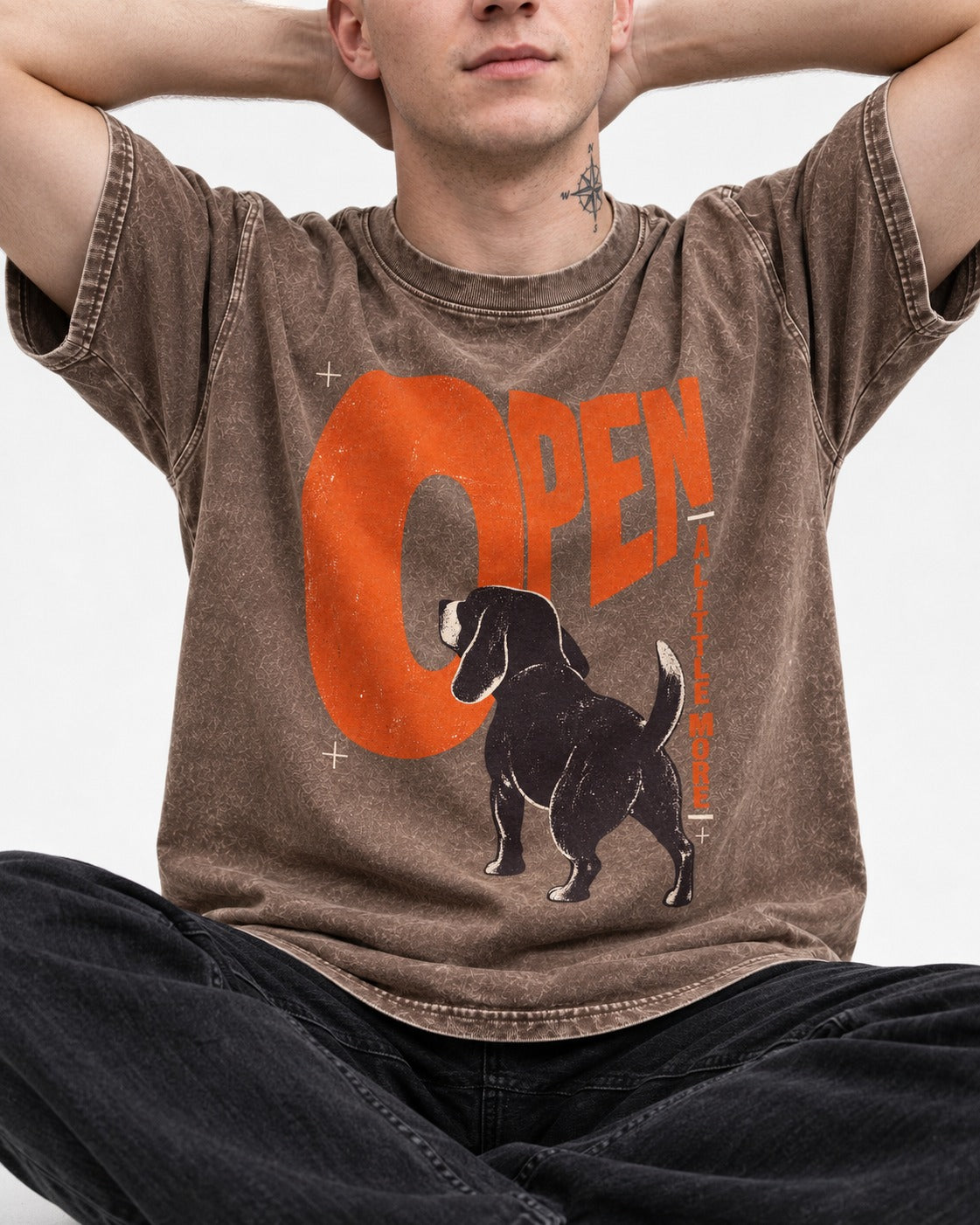 Open a Little More Beagle Washed Tee in Coffee, worn by a seated model