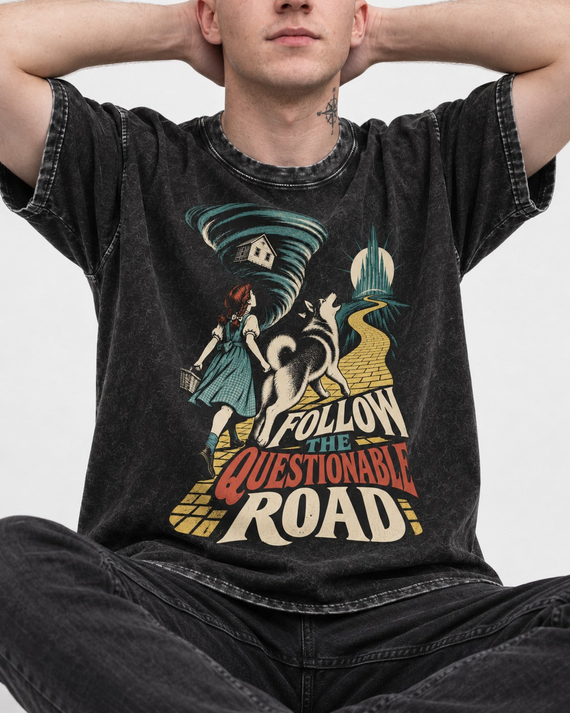 Husky Follow the Questionable Road Tornado Graphic Washed Tee in Black, worn by a seated model
