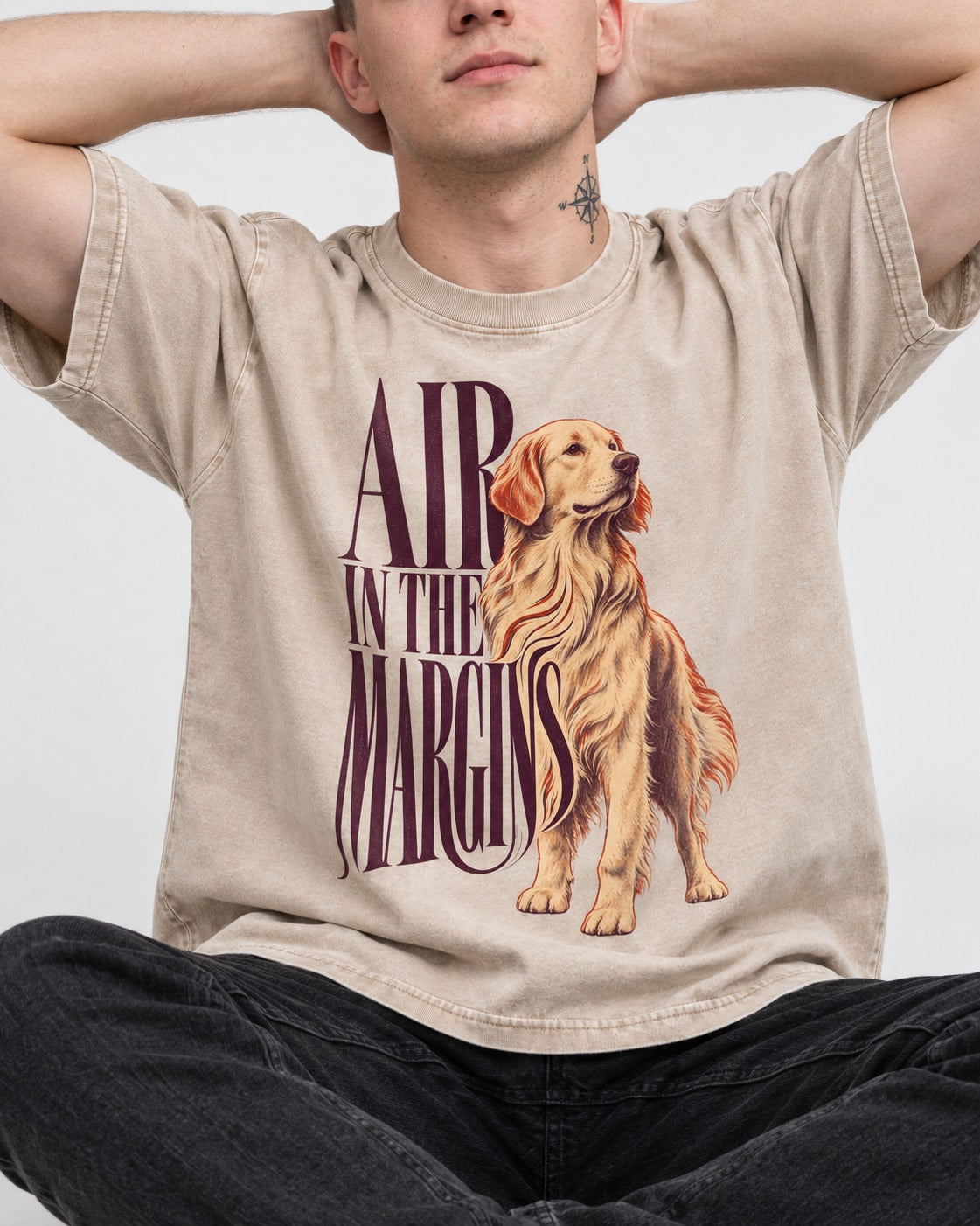 Golden Retriever In the Margins Washed Tee in Apricot, worn by a seated model