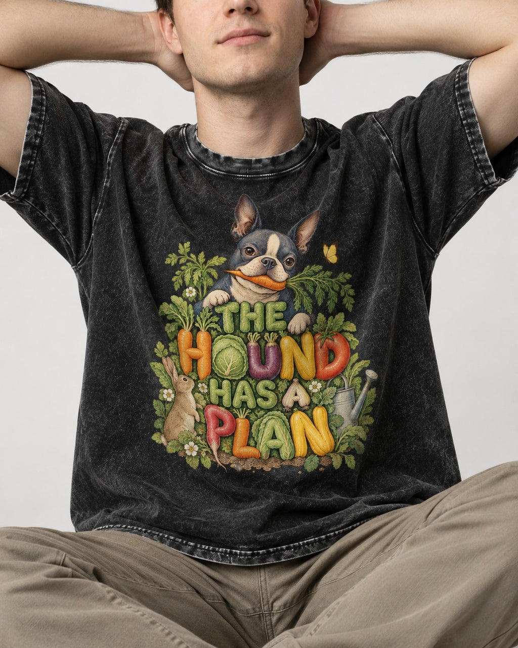 The Hound Has a Plan Boston Terrier Washed Tee in Black, worn by a seated model