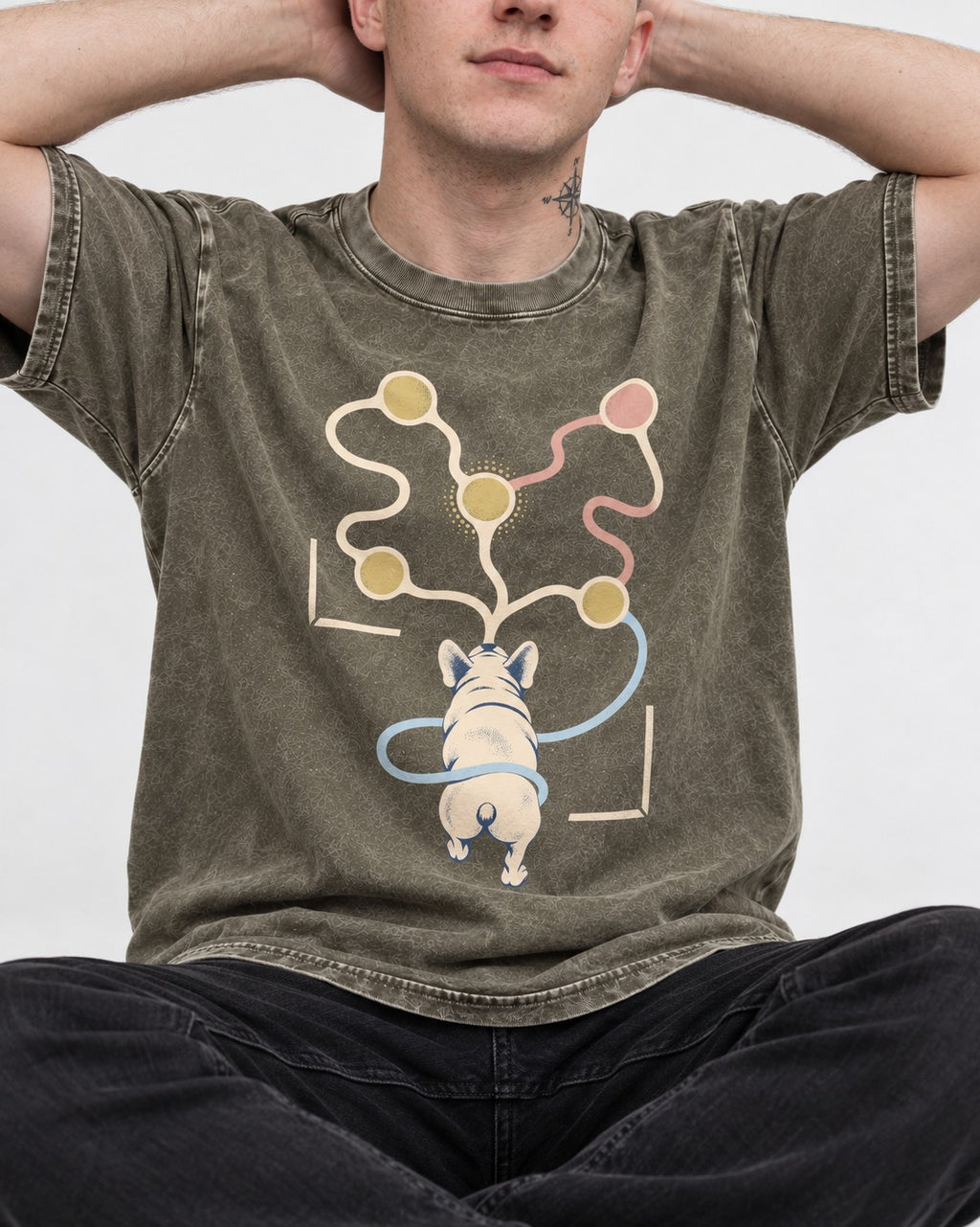 Frenchie Scent Circuit Rear View Graphic Washed Tee in Army Green, worn by a seated model