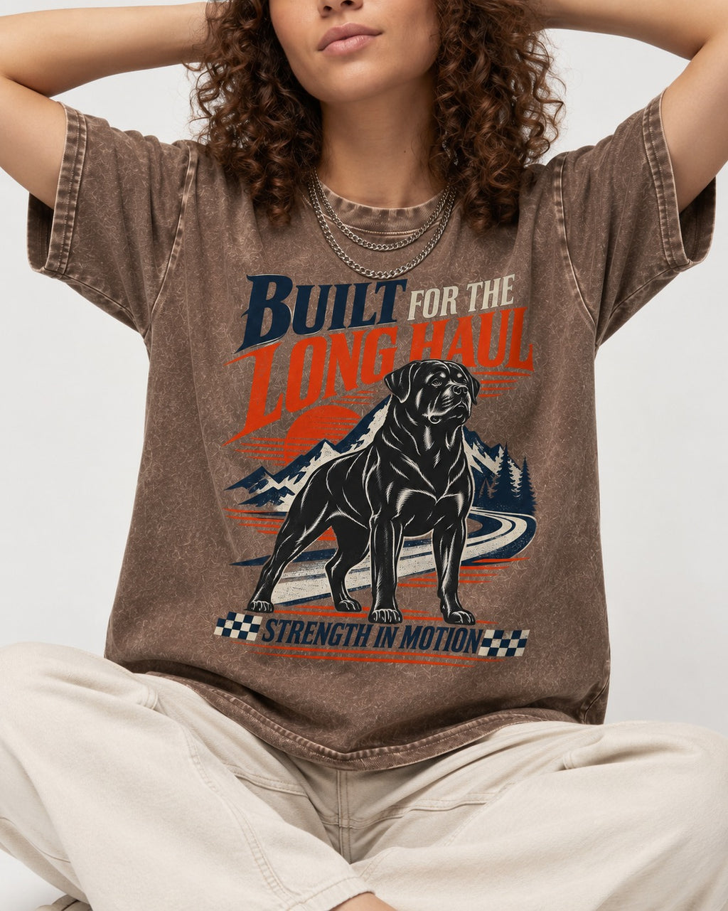Built for the Long Haul Rottweiler Strength in Motion Washed Tee in Coffee, worn by a seated model
