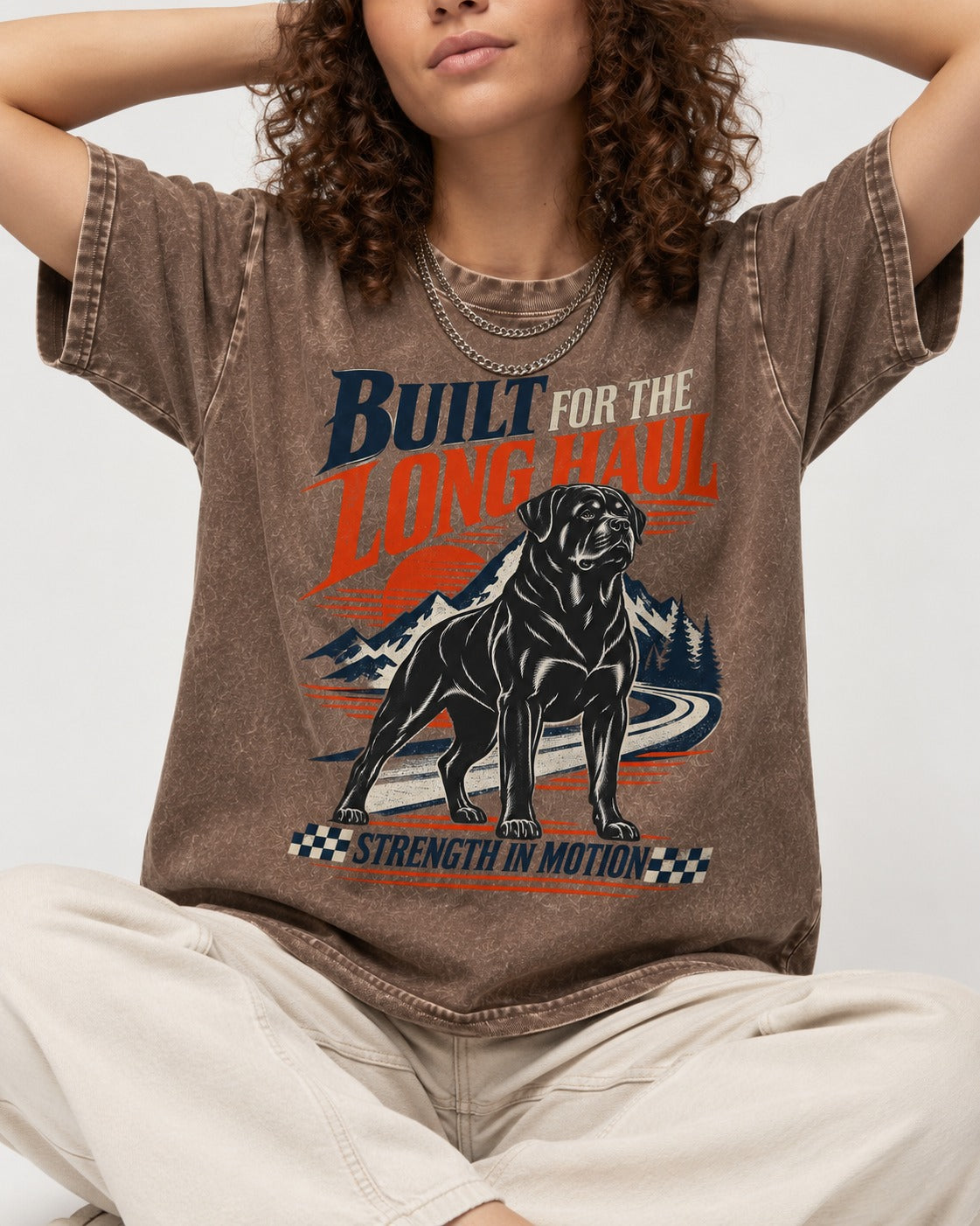 Built for the Long Haul Rottweiler Strength in Motion Washed Tee in Coffee, worn by a seated model