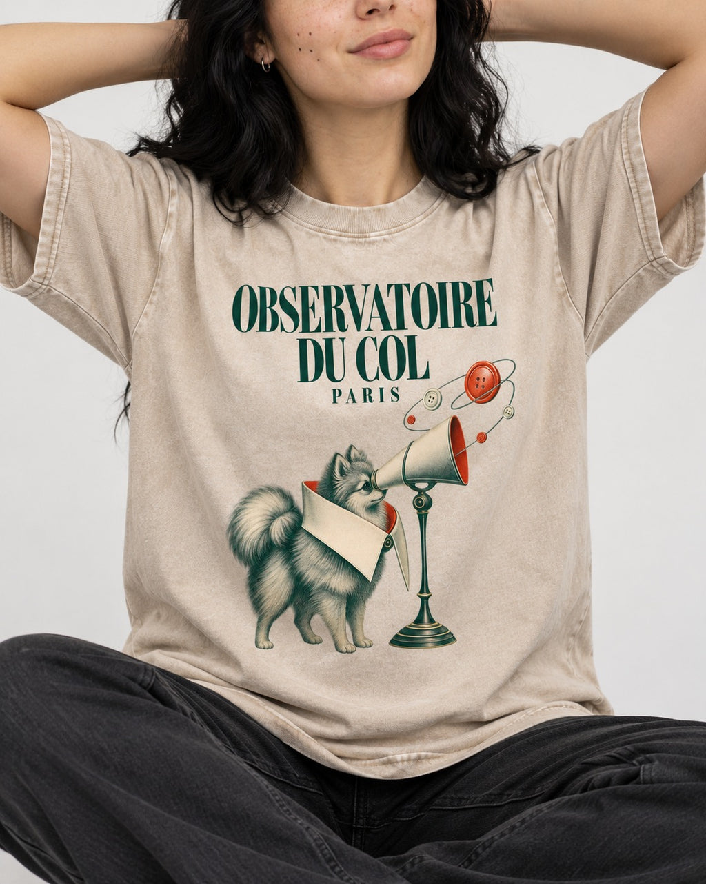 Pomeranian Observatoire Du Col Washed Tee in Apricot, worn by a seated model
