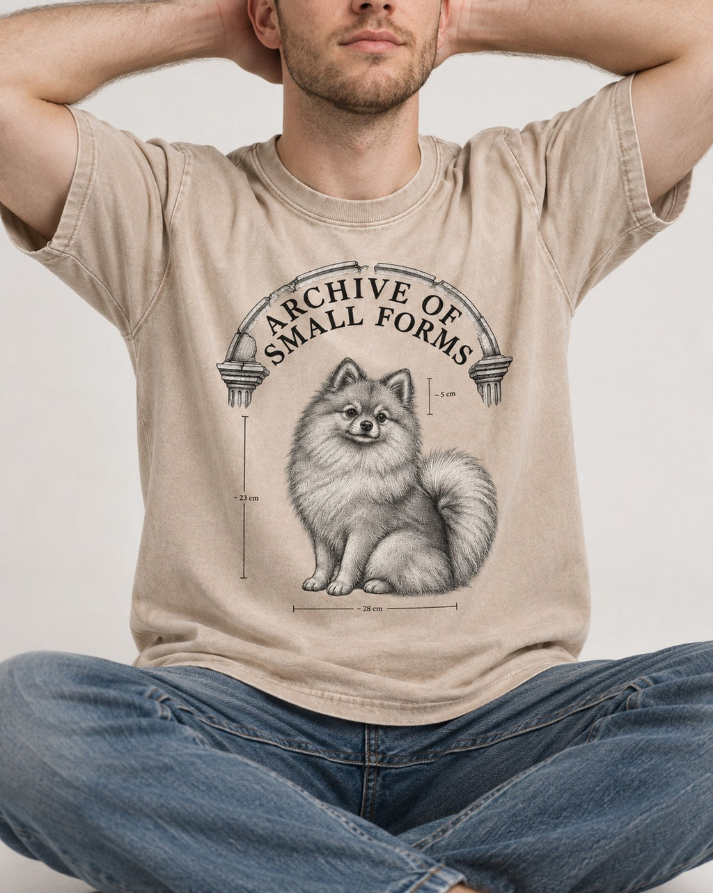 Pomeranian Archive of Small Forms Washed Tee in Apricot, worn by a seated model