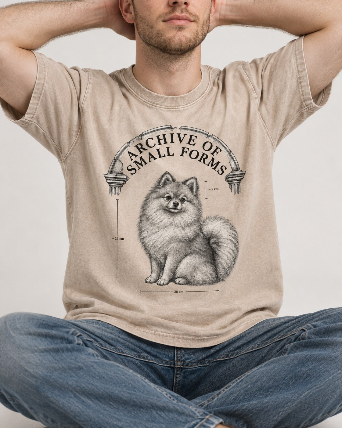 Pomeranian Archive of Small Forms Washed Tee in Apricot, worn by a seated model
