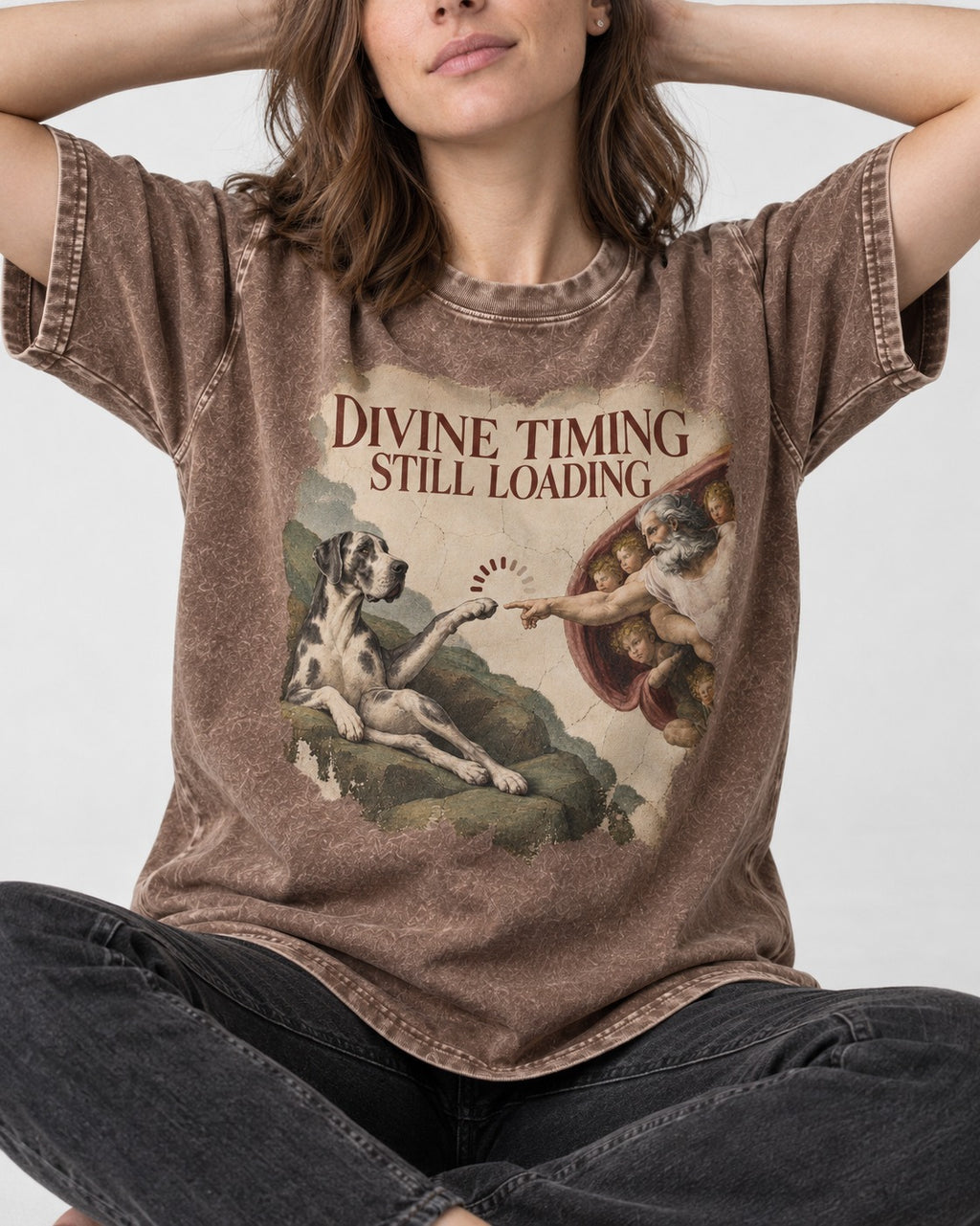 Great Dane Divine Timing Still Loading Washed Tee in Coffee, worn by a seated model