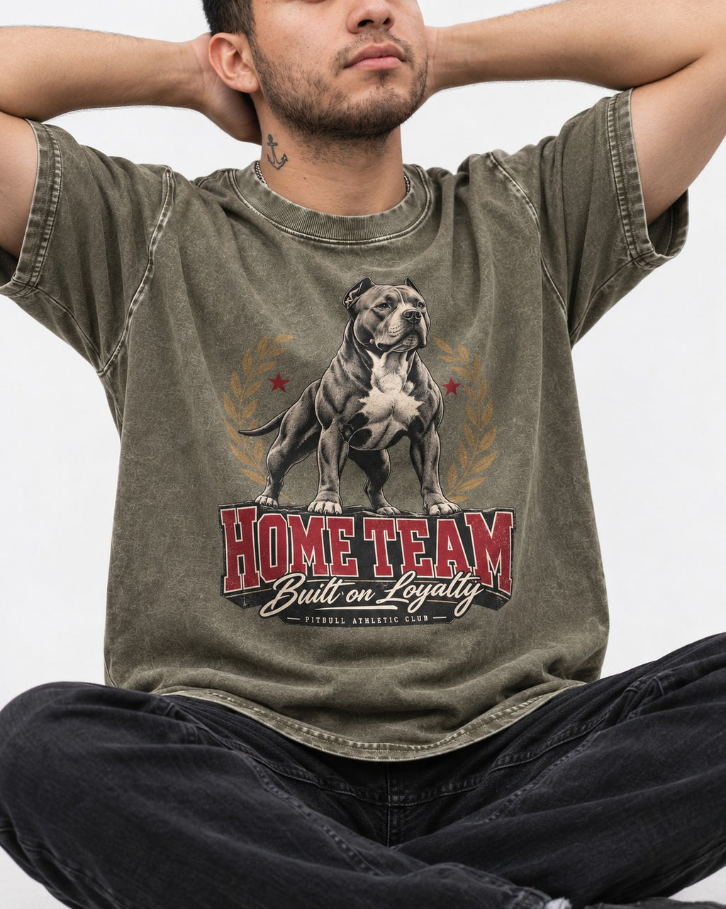 Pitbull Home Team Loyalty Crest Graphic Washed Tee in Army Green, worn by a seated model