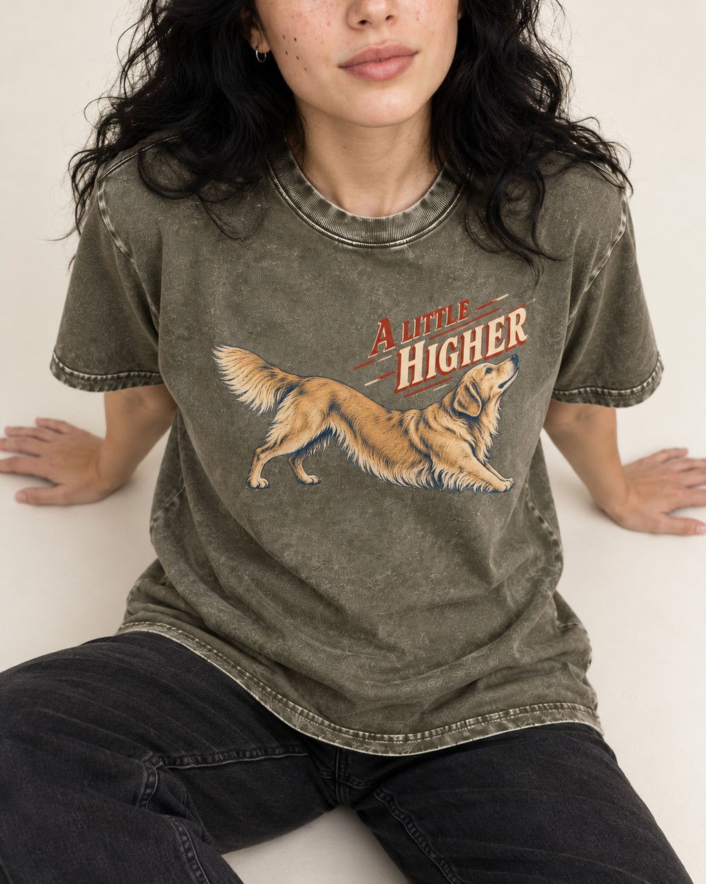 Golden Retriever A Little Higher Play Bow Graphic Washed Tee in Army Green, worn by a seated model