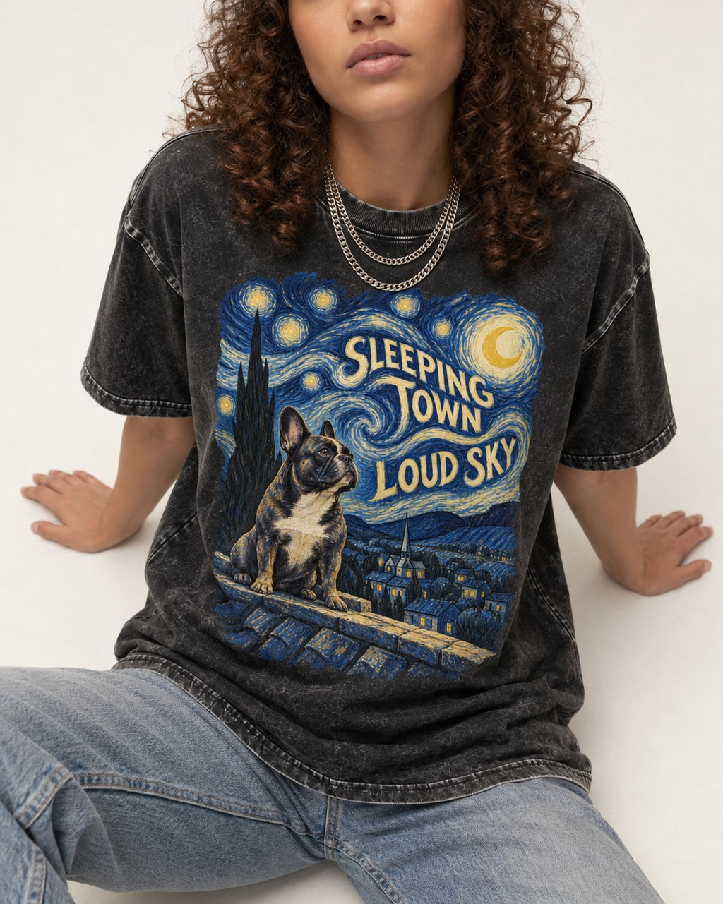 Frenchie Sleeping Town Loud Sky Rooftop Graphic Washed Tee in Black, worn by a seated model