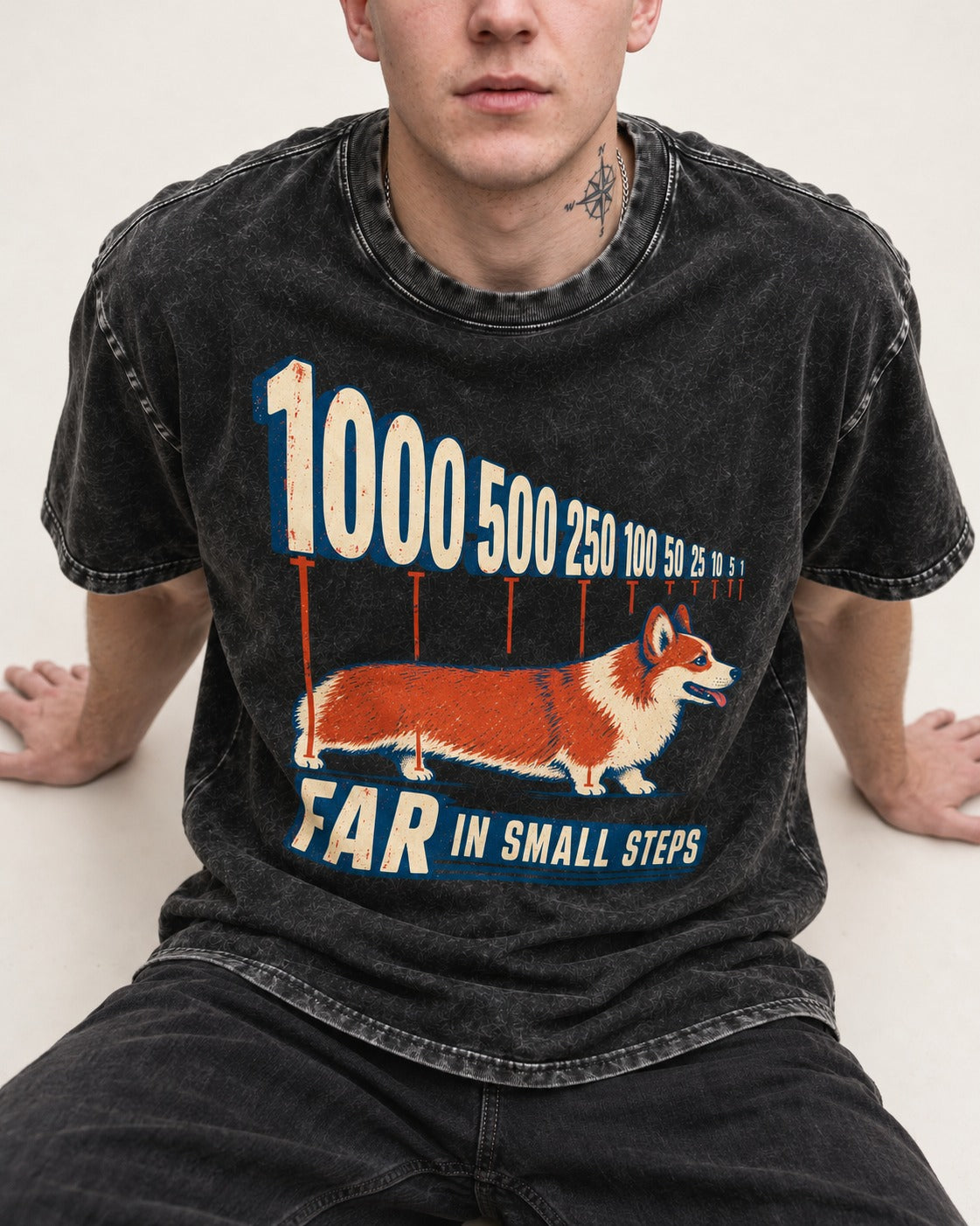 Corgi Far in Small Steps Washed Tee in Black, worn by a seated model