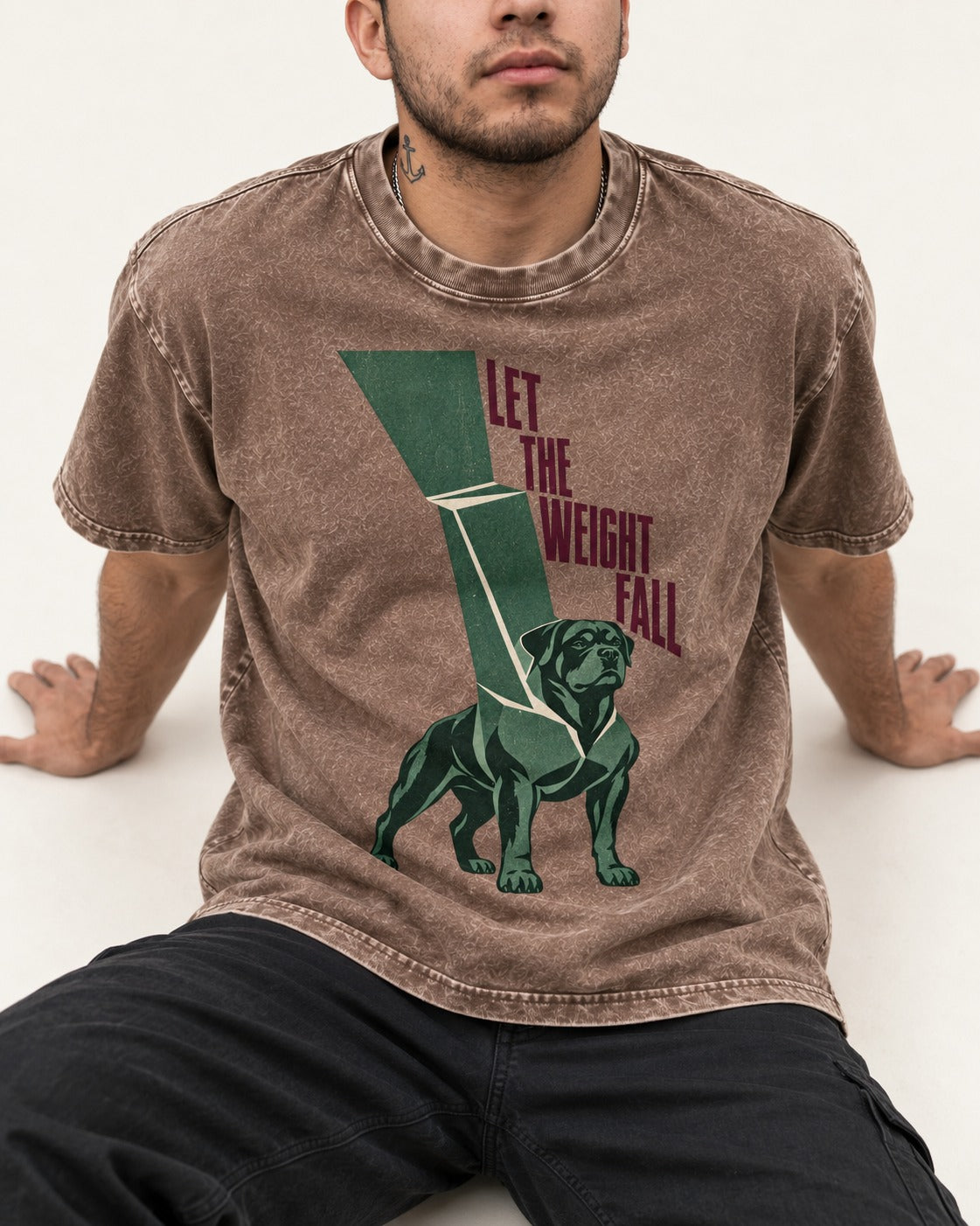 Let the Weight Fall Rottweiler Washed Tee in Coffee, worn by a seated model
