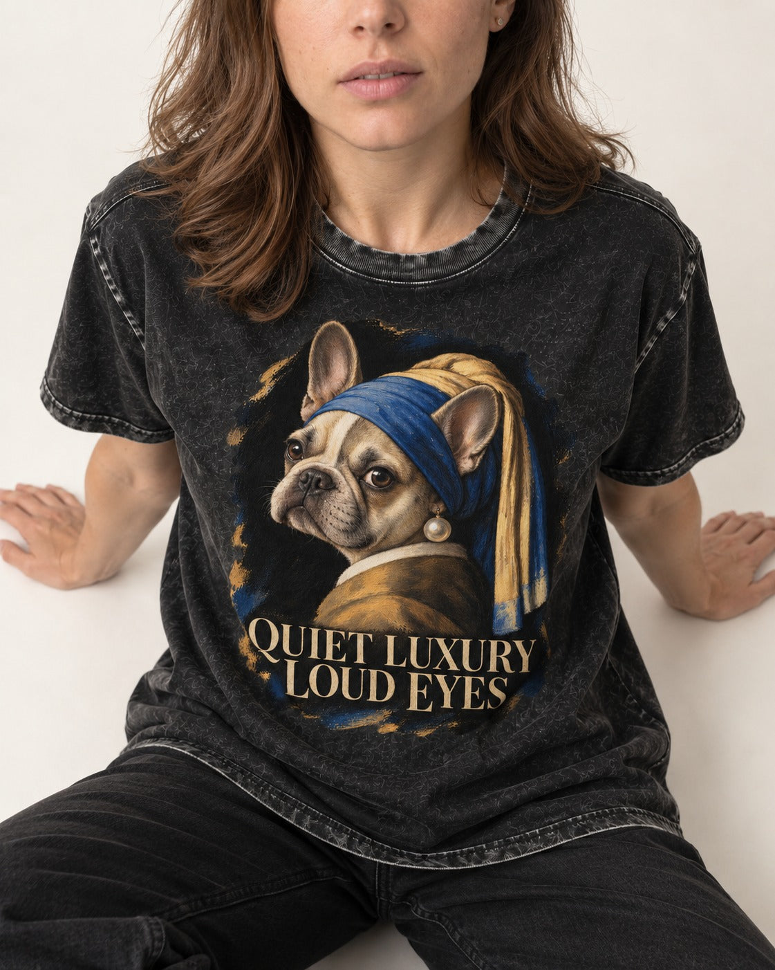 Frenchie Quiet Luxury Loud Eyes Pearl Portrait Graphic Washed Tee in Black, worn by a seated model