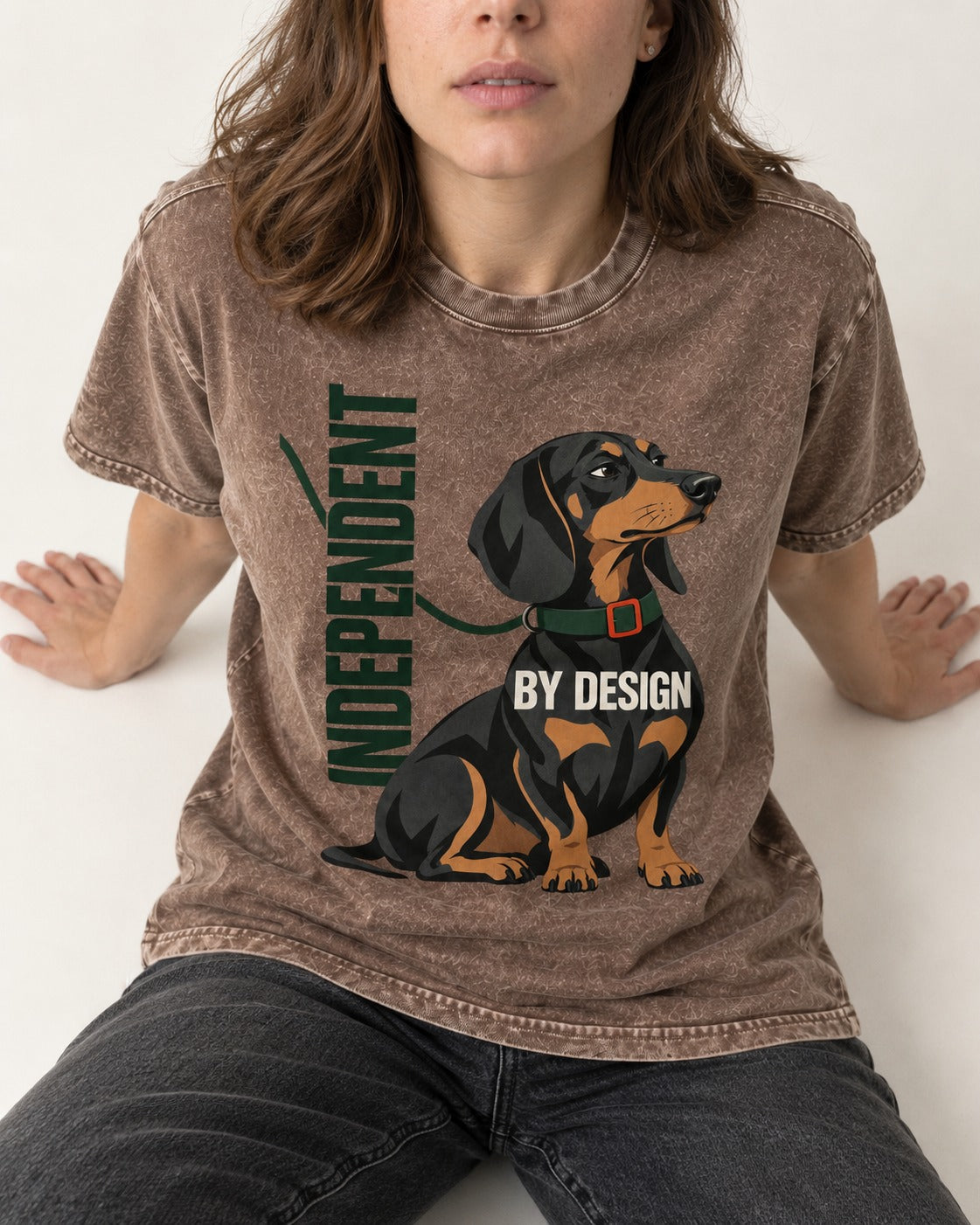 Independent Dachshund Washed Tee in Coffee, worn by a seated model
