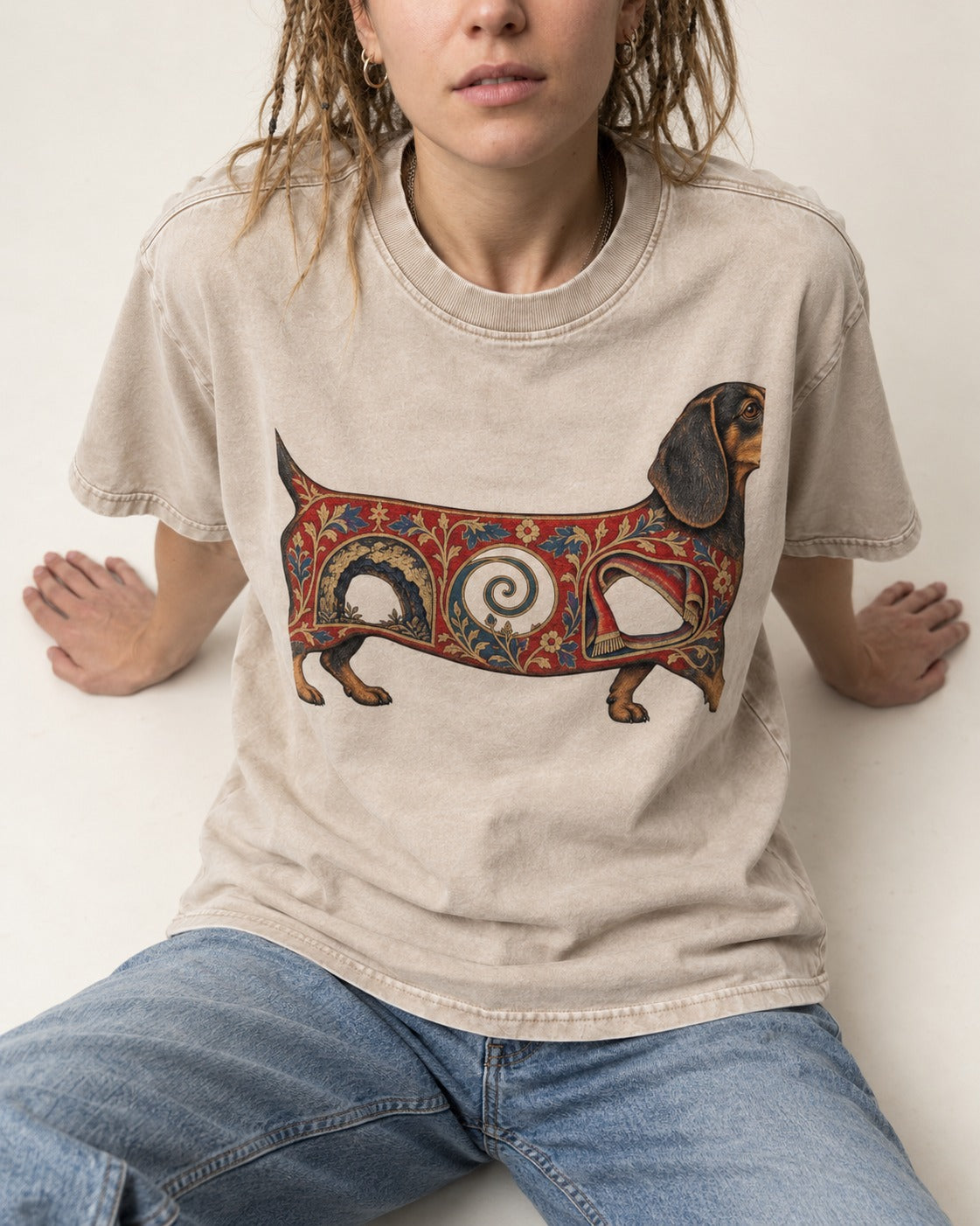 Dachshund Ever After Washed Tee in Apricot, worn by a seated model