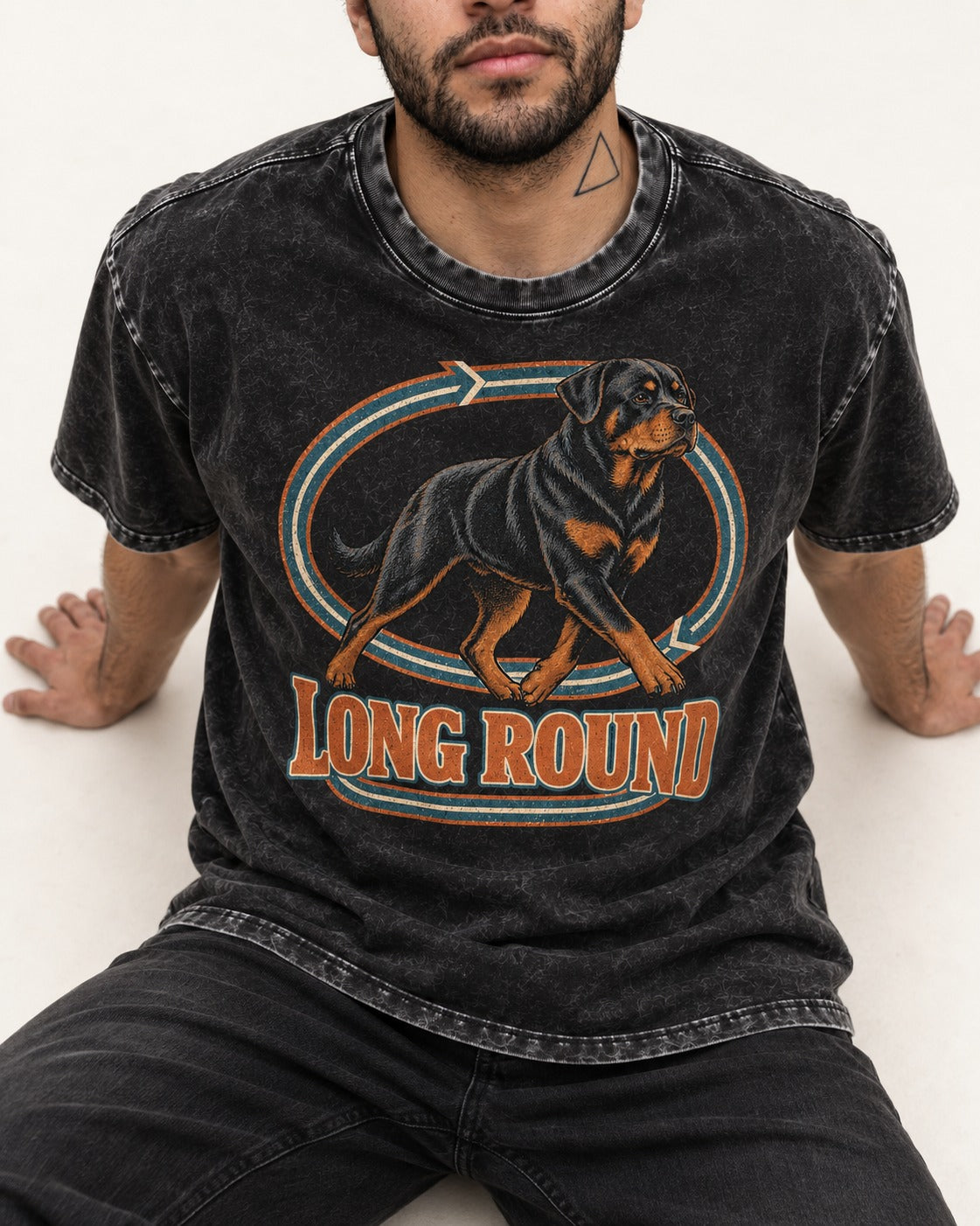 Rottweiler Long Round Circular Track Graphic Washed Tee in Black, worn by a seated model