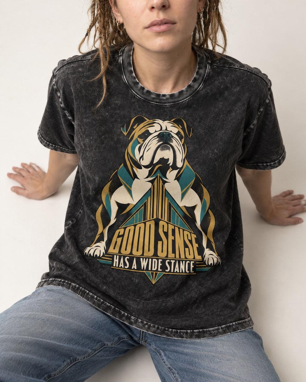 Good Sense Has a Wide Stance English Bulldog Graphic Washed Tee in Black, worn by a seated model