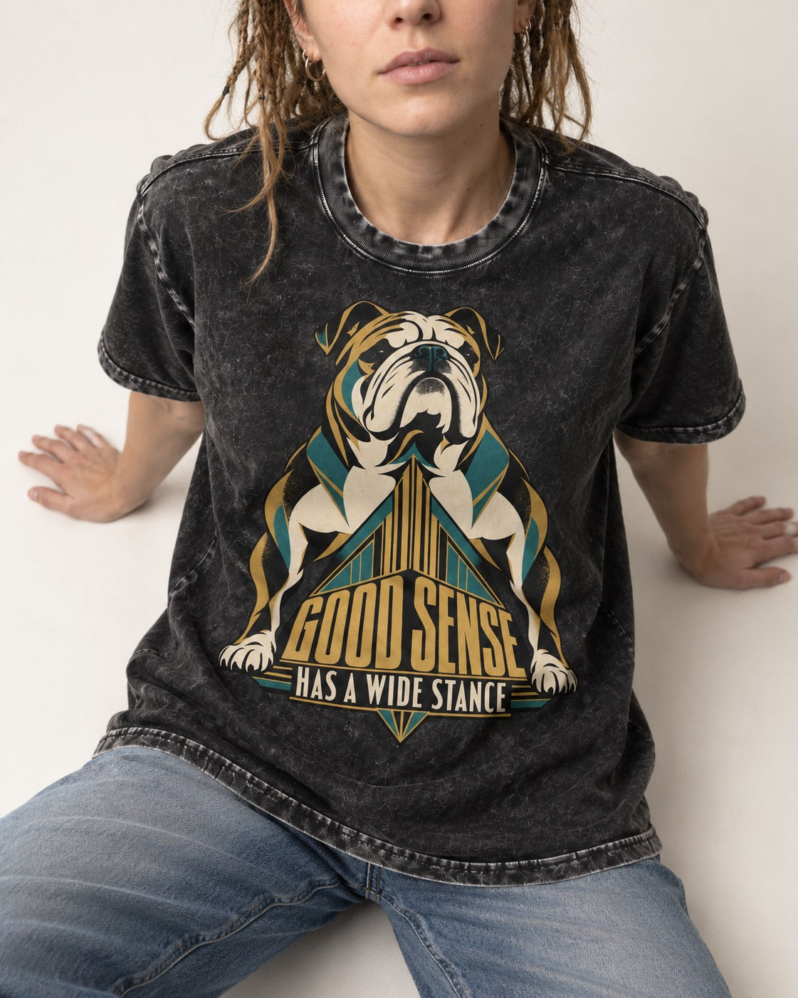Good Sense Has a Wide Stance English Bulldog Graphic Washed Tee in Black, worn by a seated model
