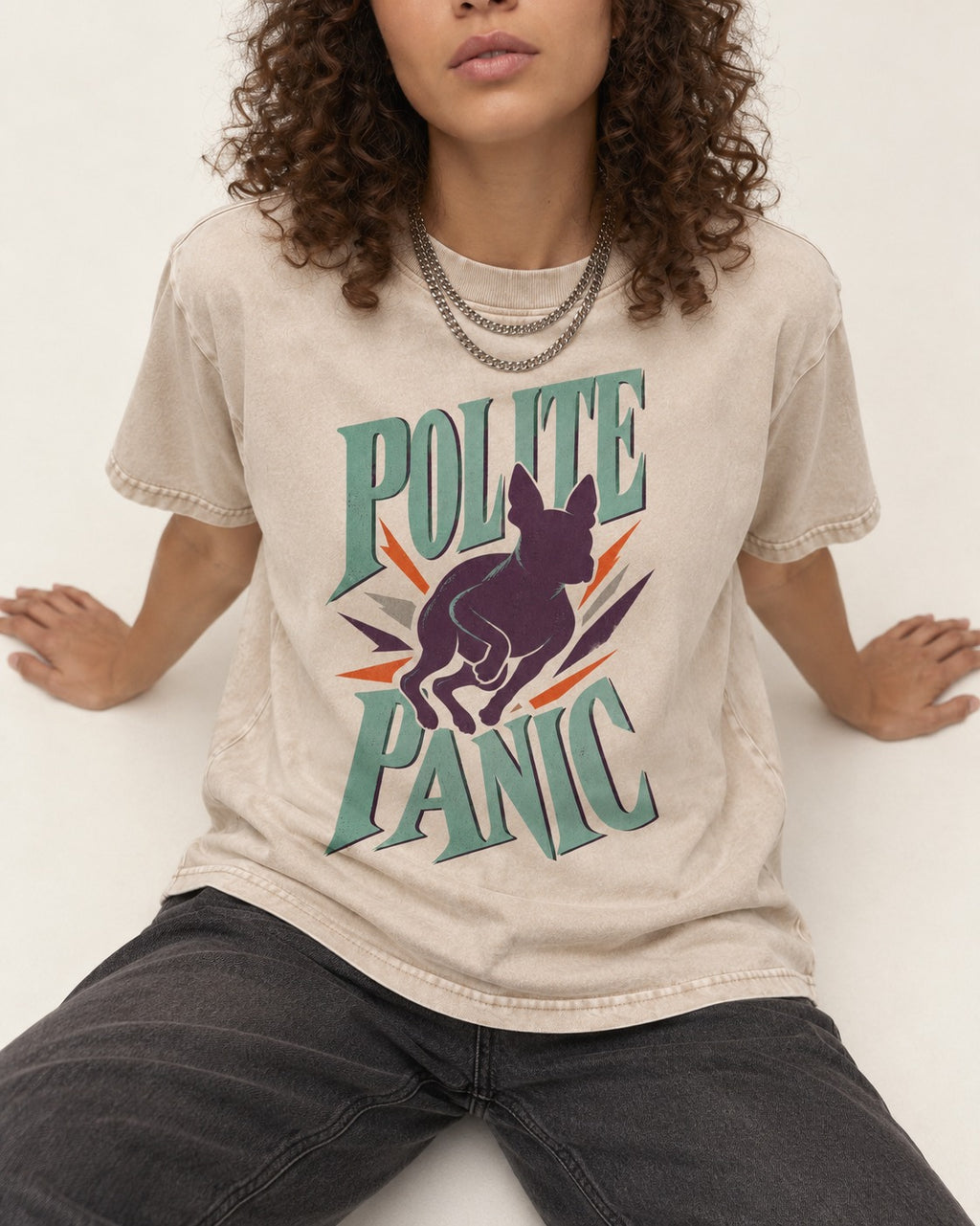 Polite Panic Boston Terrier Washed Tee in Apricot, worn by a seated model