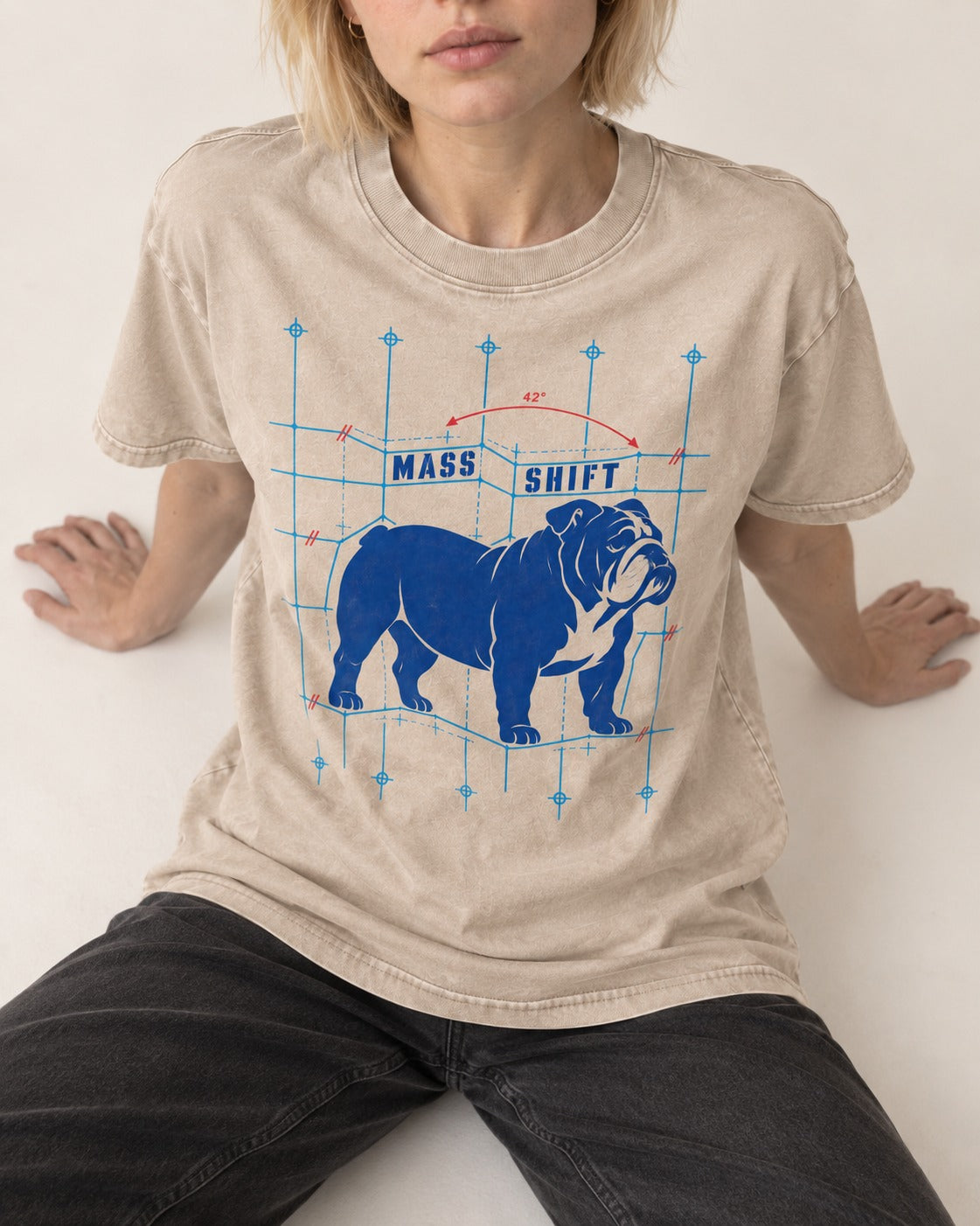 Mass Shift English Bulldog Washed Tee in Apricot, worn by a seated model