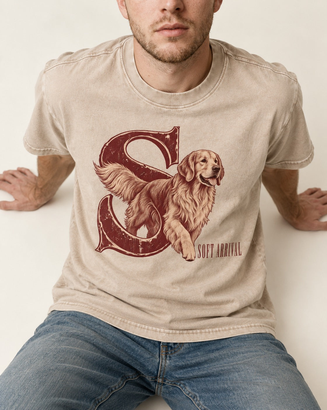 Soft Arrival Golden Retriever Washed Tee in Apricot, worn by a seated model