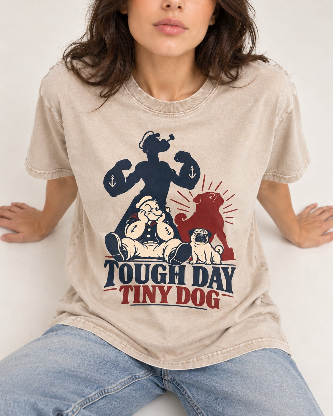 Tough Day Tiny Pug Washed Tee in Apricot, worn by a seated model