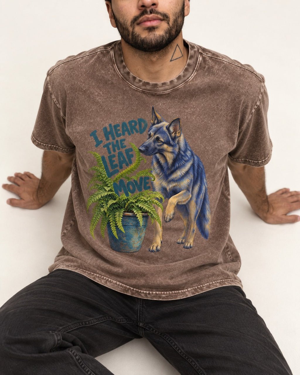 German Shepherd Dog Heard the Leaf Move Washed Tee in Coffee, worn by a seated model