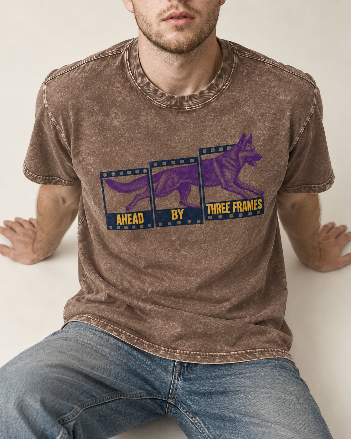 German Shepherd Dog Ahead by Three Frames Washed Tee in Coffee, worn by a seated model