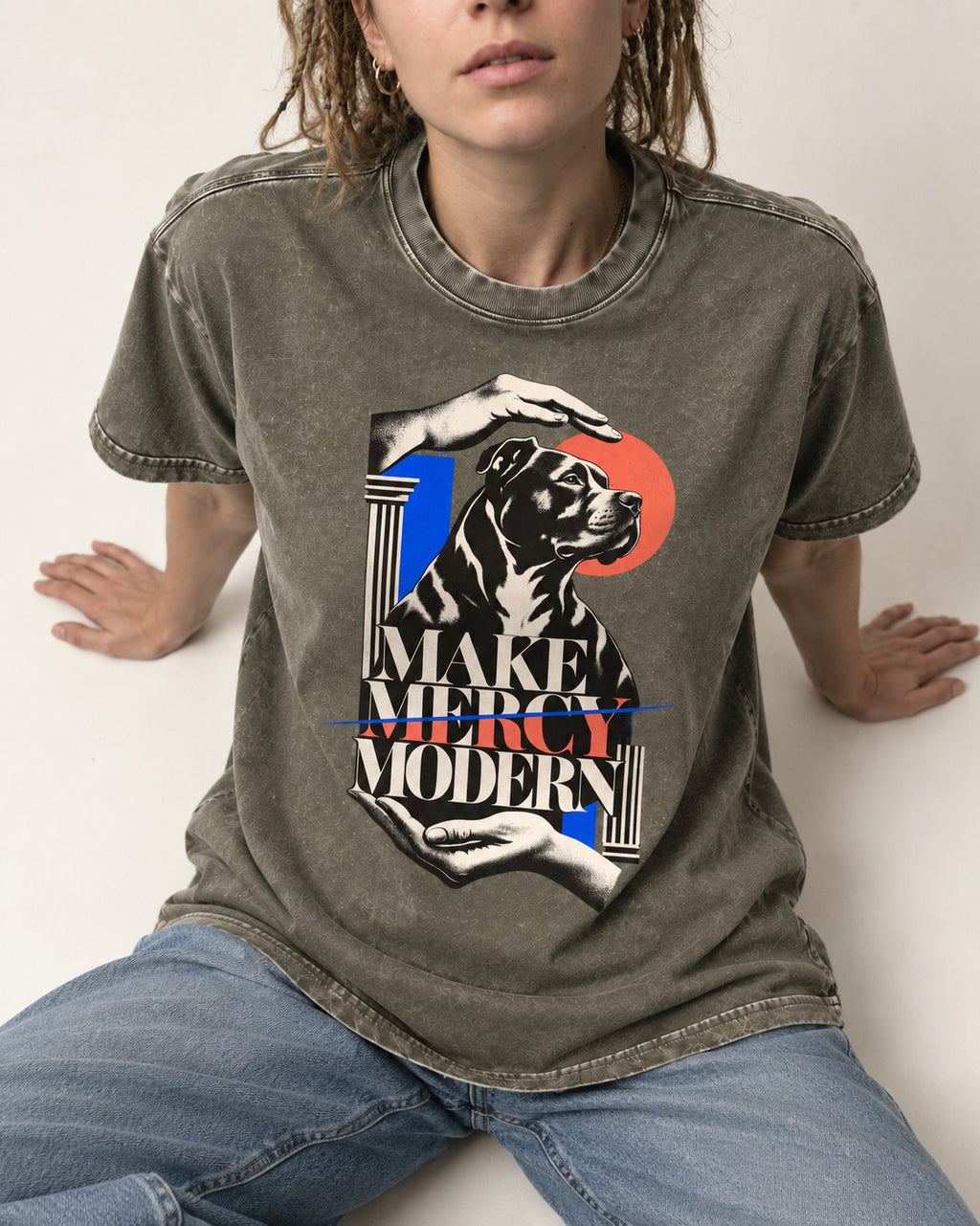 Pitbull Make Mercy Modern Protective Hands Graphic Washed Tee in Army Green, worn by a seated model