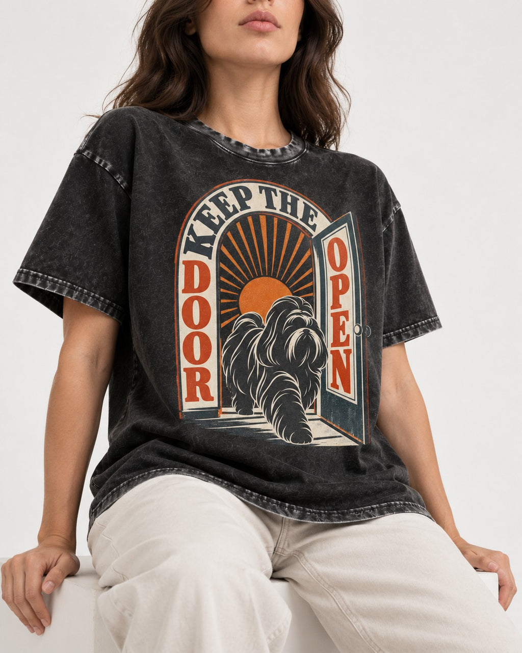 Shih Tzu Keep the Door Open Retro Doorway Graphic Washed Tee in Black, worn by a seated model