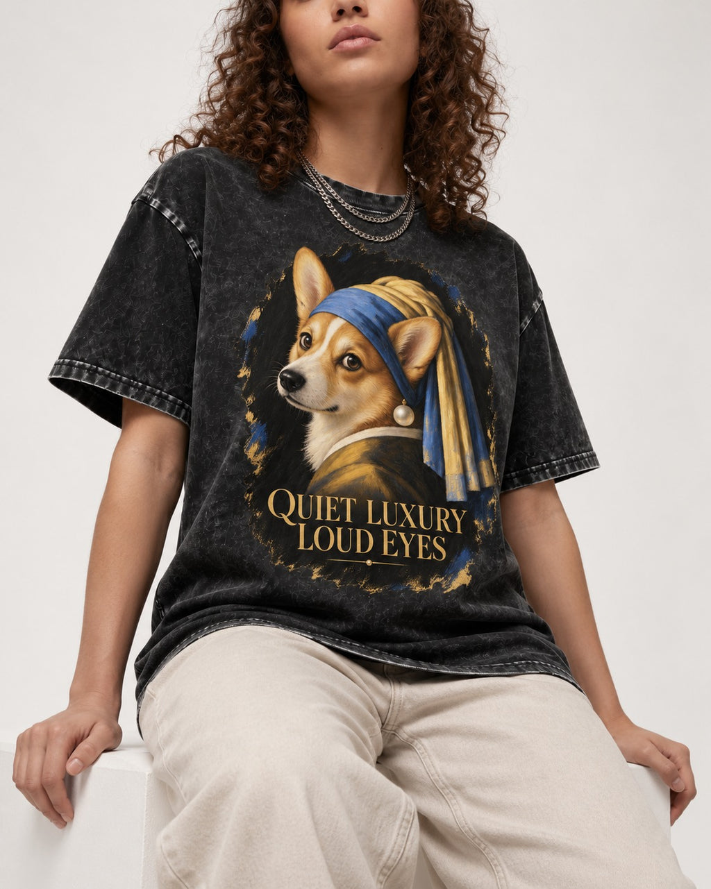 Corgi Quiet Luxury Loud Eyes Pearl Earring Portrait Washed Tee in Black, worn by a seated model