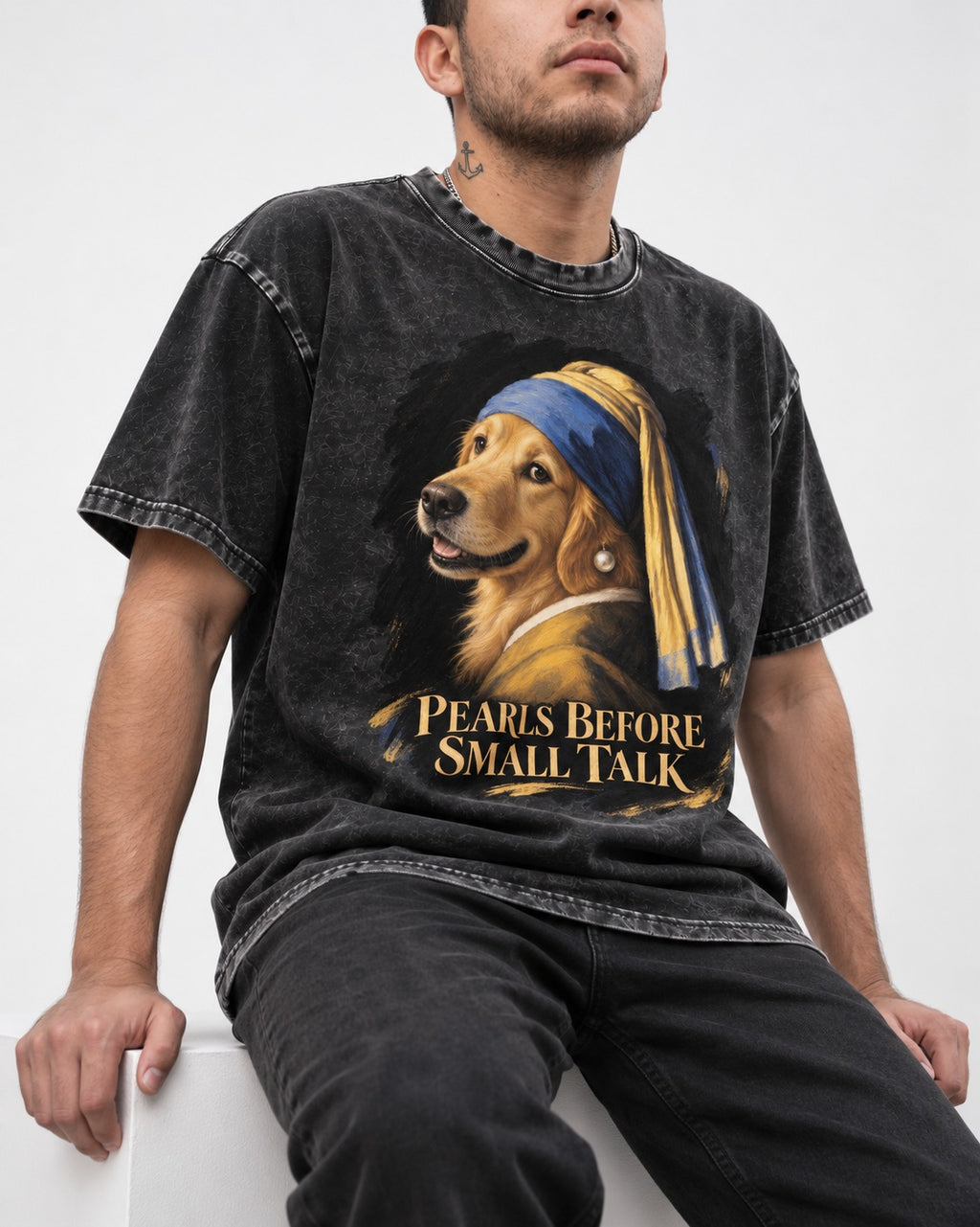 Pearls Before Small Talk Pearl Portrait Golden Retriever Graphic Washed Tee in Black, worn by a seated model