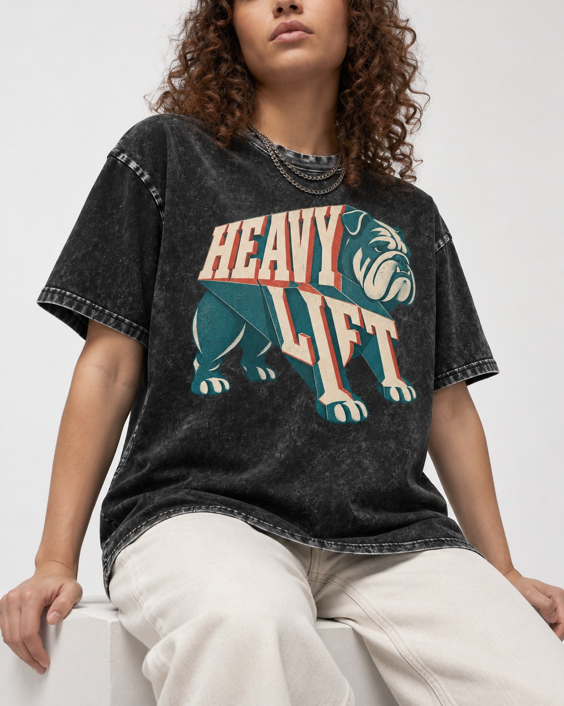 English Bulldog Heavy Lift Dimensional Type Washed Tee in Black, worn by a seated model
