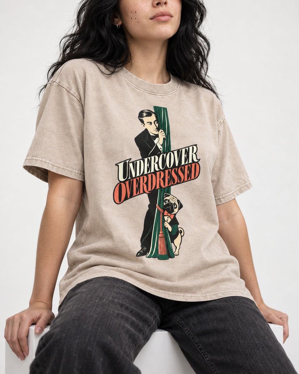 Undercover Overdressed Pug Washed Tee in Apricot, worn by a seated model