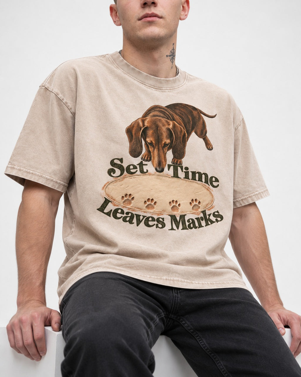 Dachshund Time Leaves Marks Washed Tee in Apricot, worn by a seated model