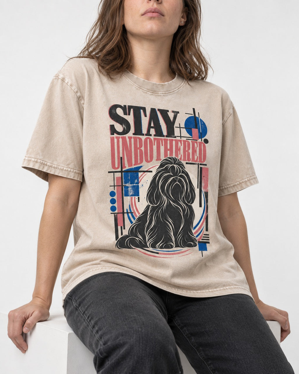 Stay Unbothered Shih Tzu Washed Tee in Apricot, worn by a seated model
