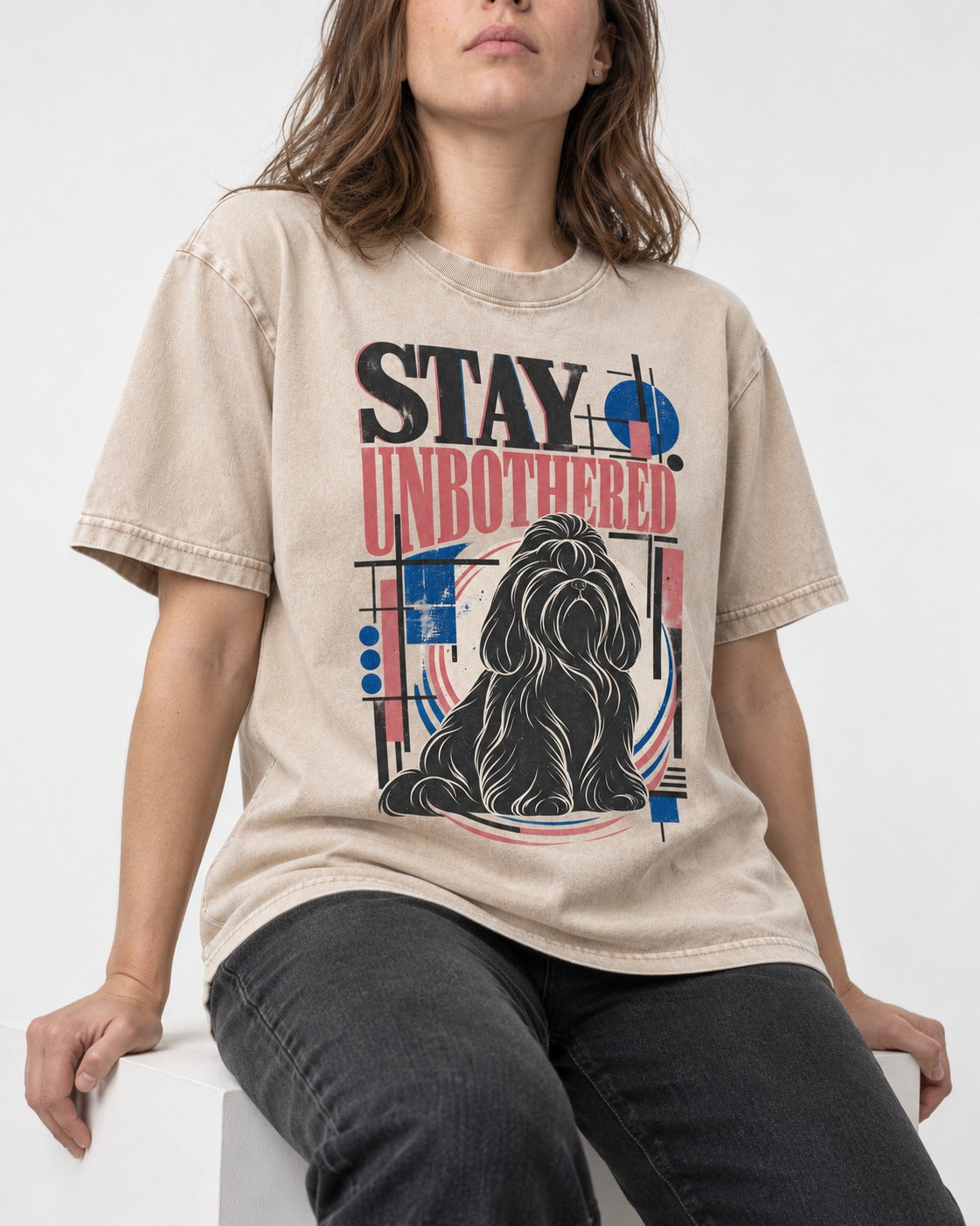 Stay Unbothered Shih Tzu Washed Tee in Apricot, worn by a seated model