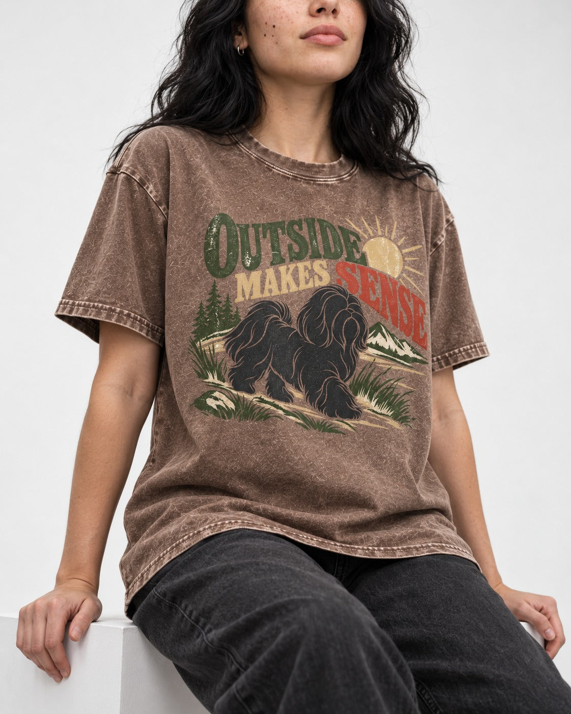 Shih Tzu Outside Makes Sense Mountain Trail Graphic Washed Tee in Coffee, worn by a seated model