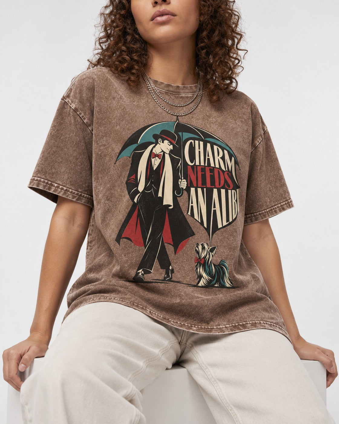 Charm Needs an Alibi Yorkshire Terrier Washed Tee in Coffee, worn by a seated model
