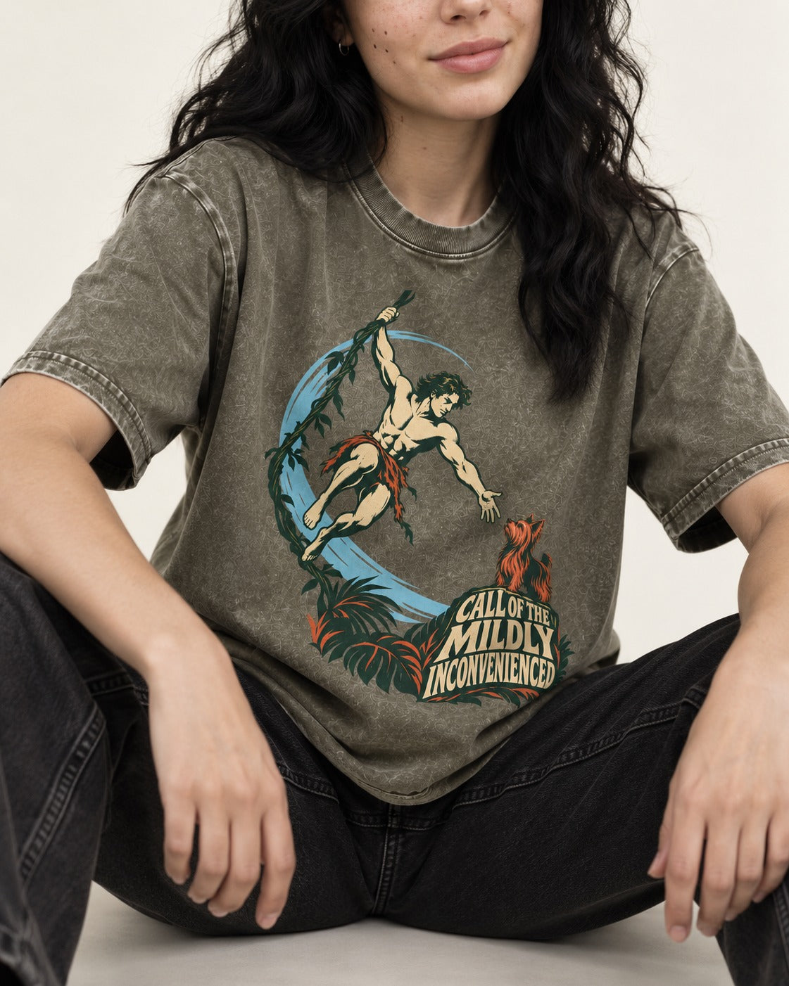 Yorkshire Terrier Call of the Mildly Inconvenienced Vine Swing Graphic Washed Tee in Army Green, worn by a seated model