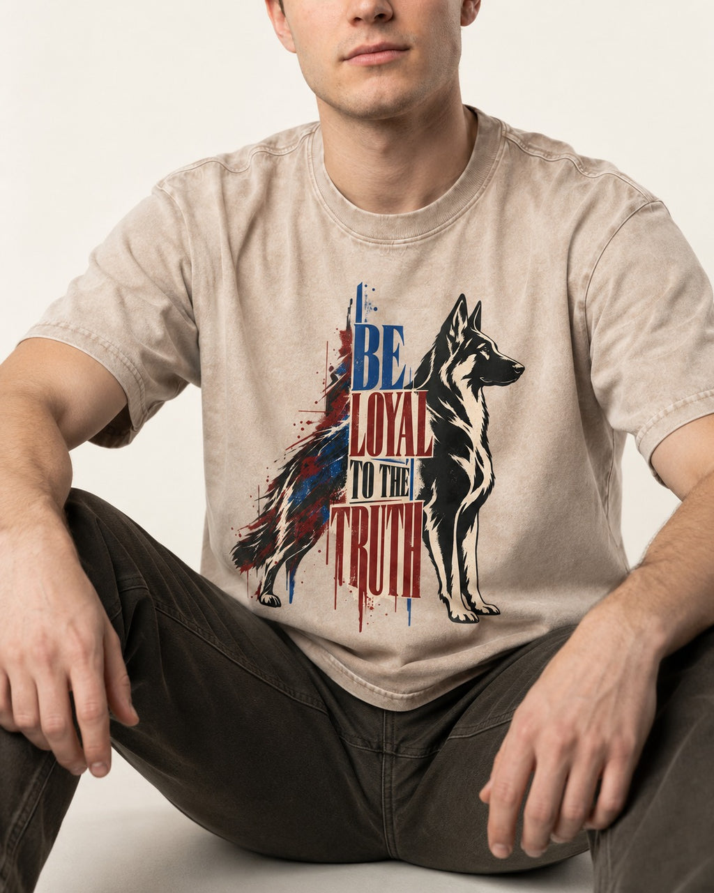 Loyal to the Truth German Shepherd Dog Washed Tee in Apricot, worn by a seated model